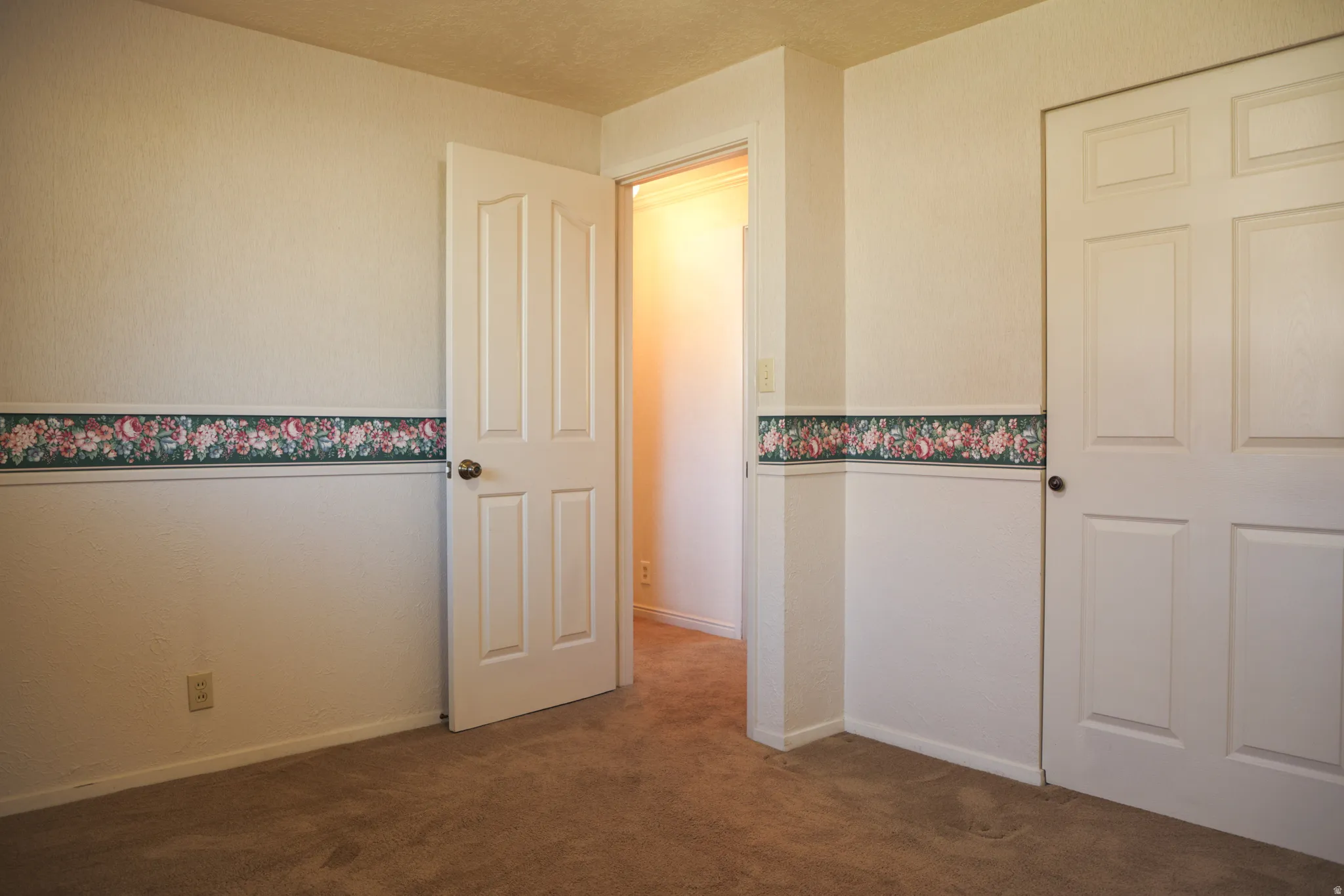 Bedroom One featuring dark colored carpet and baseboards