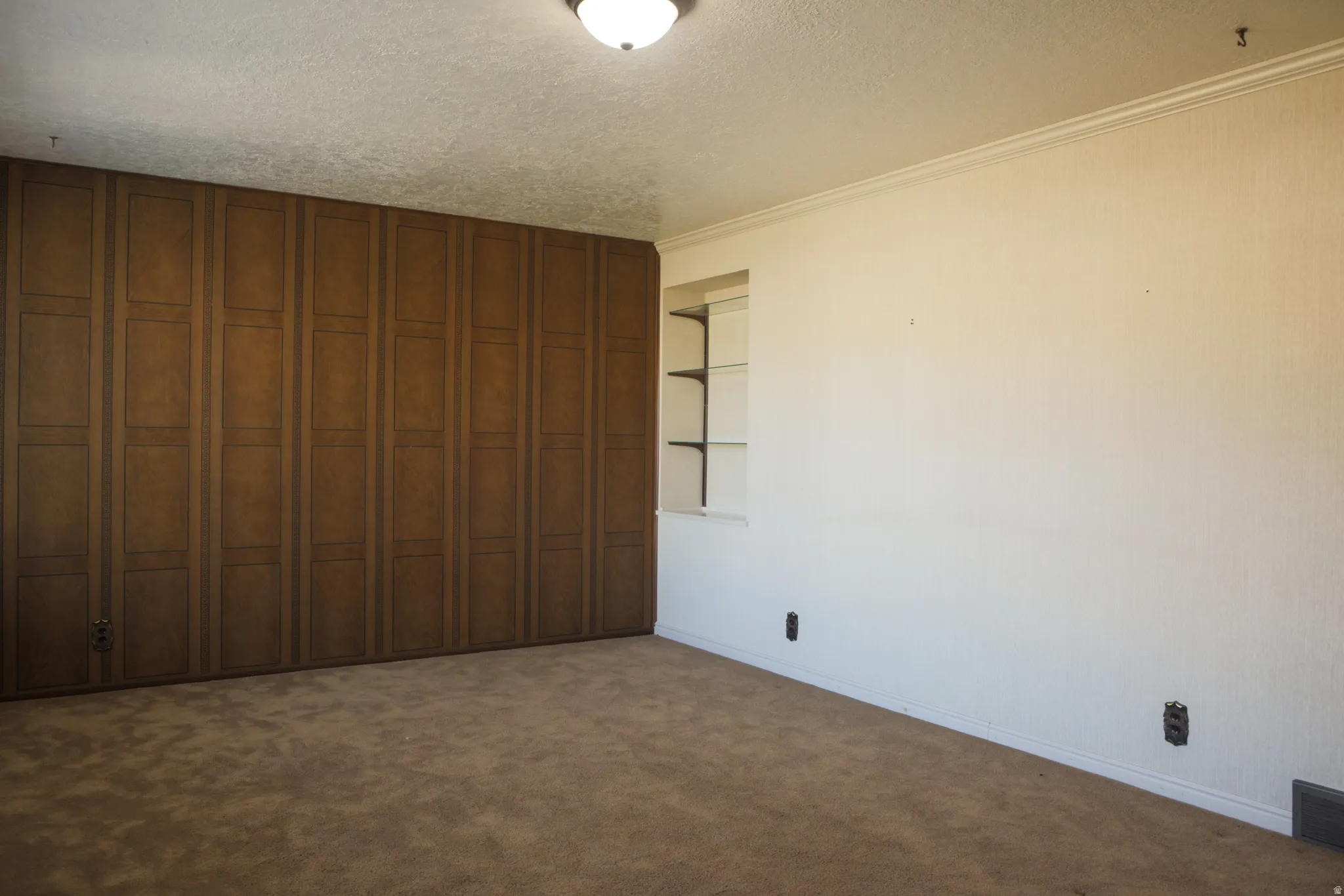 Front Room featuring a textured ceiling, dark colored carpet