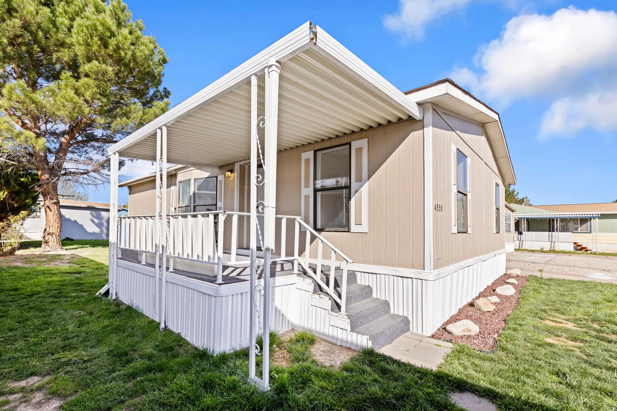 Manufactured / mobile home featuring a front yard and covered porch