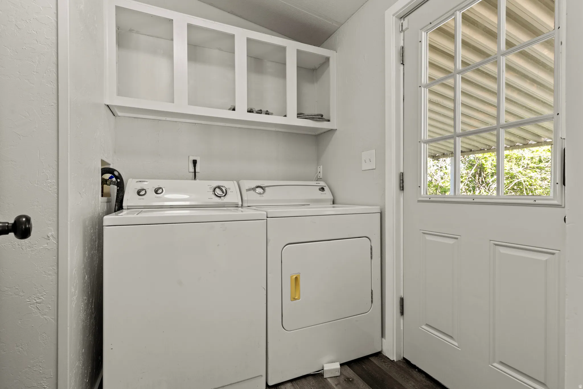 Laundry room with separate washer and dryer and dark wood-style floors