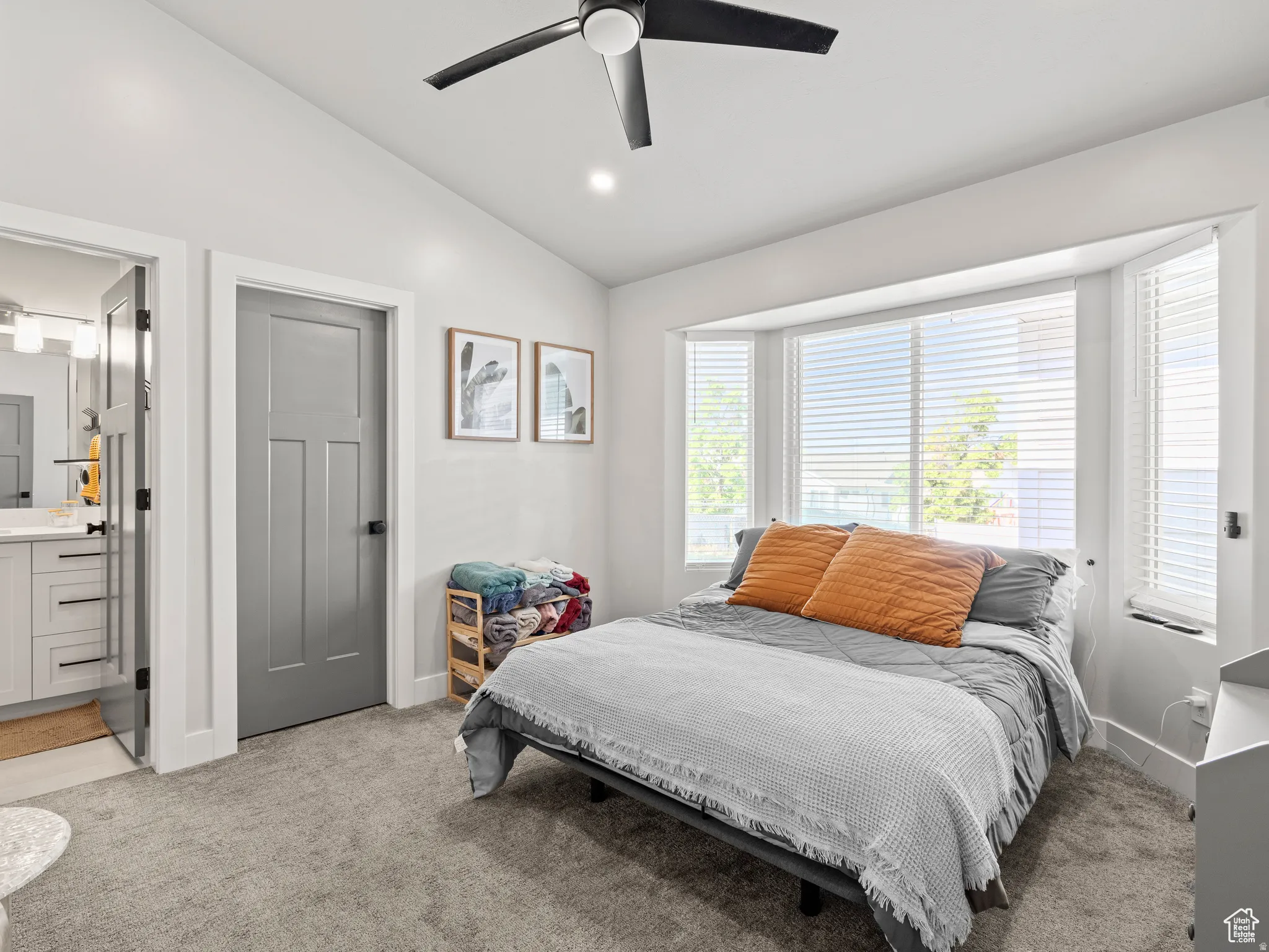 Master Bedroom with lofted vaulted ceiling, light colored carpet, ceiling fan, ensuite bath, and recessed lighting