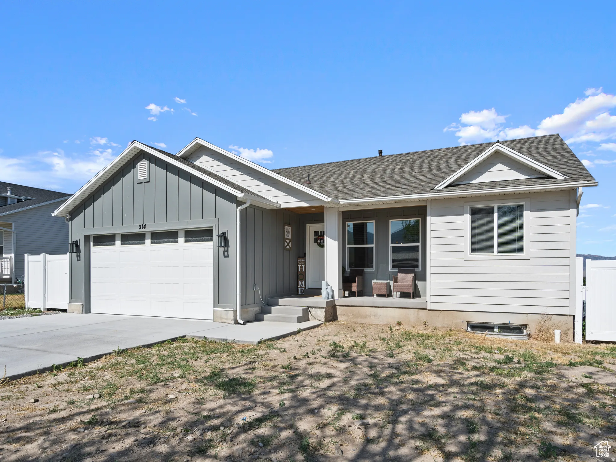 Ranch-style house featuring board and batten siding, concrete driveway, a garage, and roof with shingles