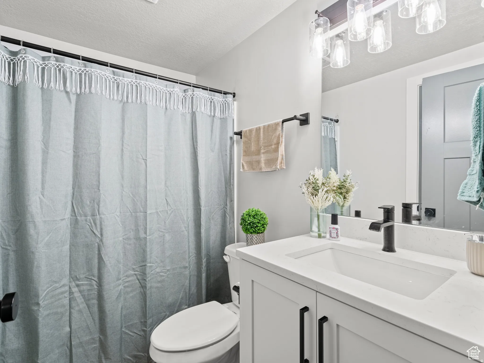 Full 2nd bath featuring vanity, a shower with curtain, and a textured ceiling