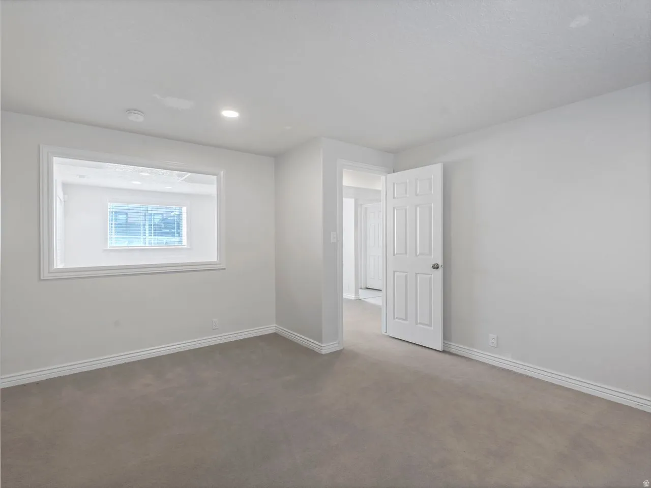 Empty room with baseboards and dark carpet