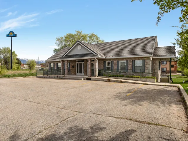 View of building exterior featuring parking