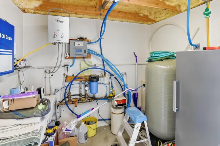 Utility room featuring tankless water heater