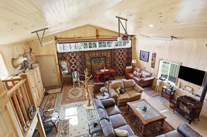 Living room featuring wooden ceiling and wooden walls
