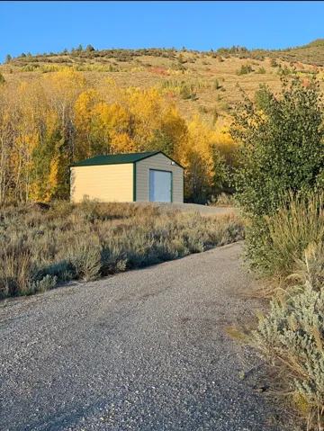 View of outdoor structure featuring driveway