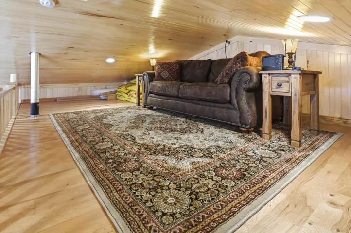 Living area featuring light wood-type flooring, wooden walls, and wooden ceiling