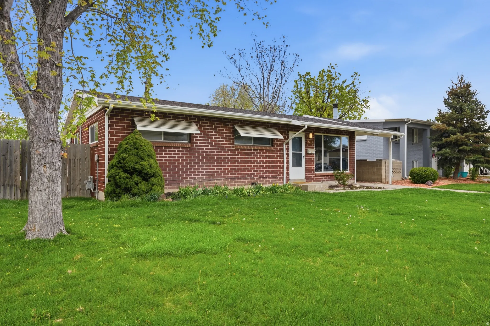 Ranch-style house with brick siding