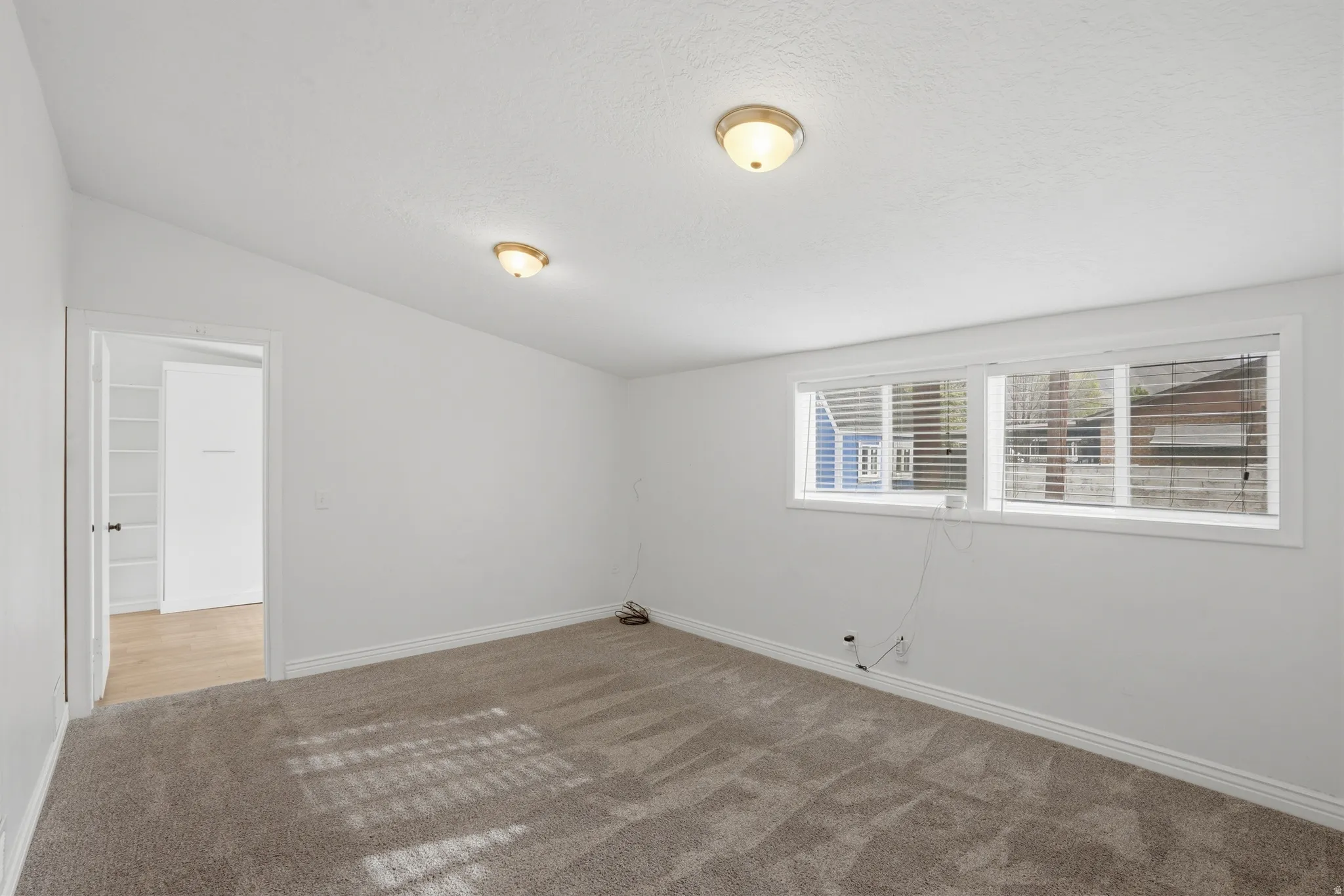 Family room with light carpet and lofted ceiling