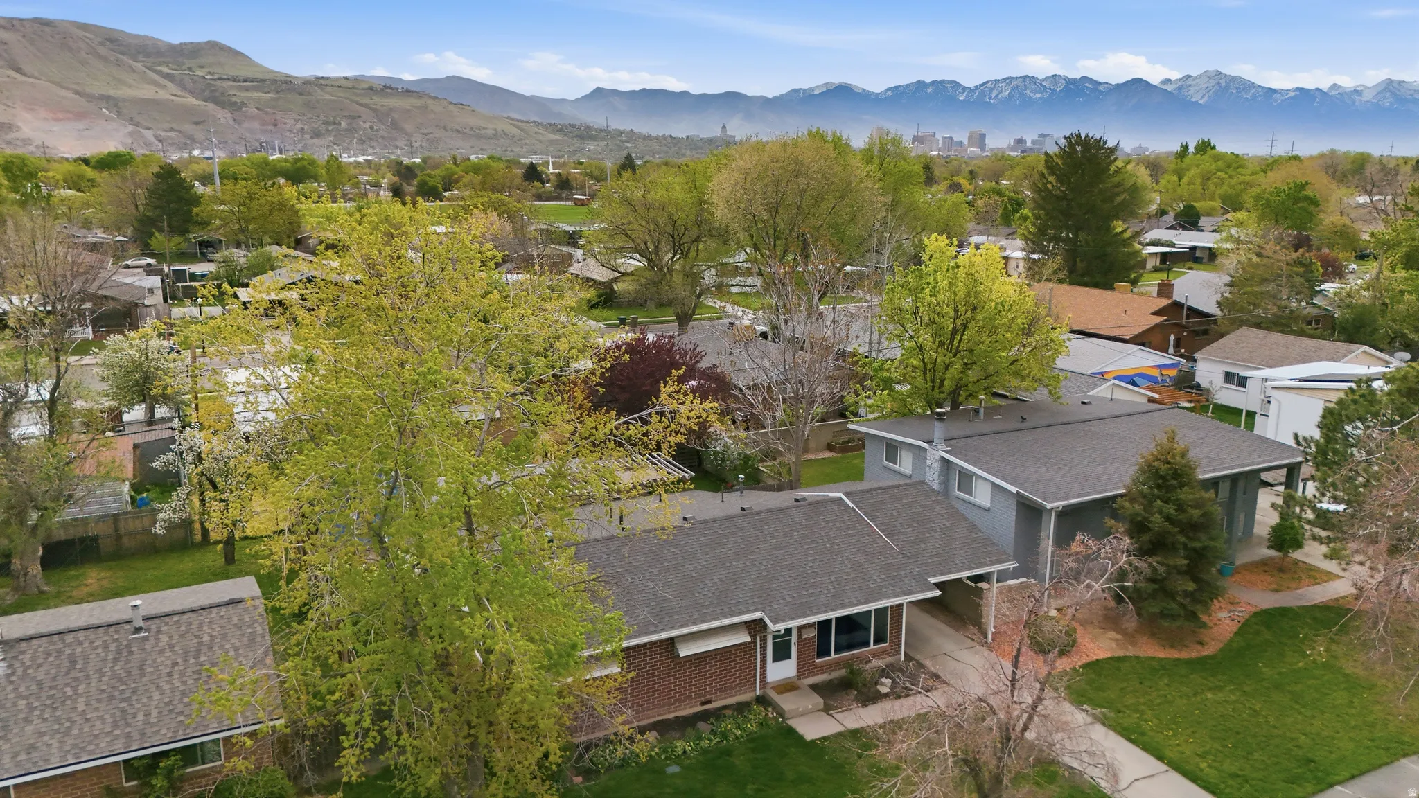 Aerial perspective of suburban area with a mountain backdrop