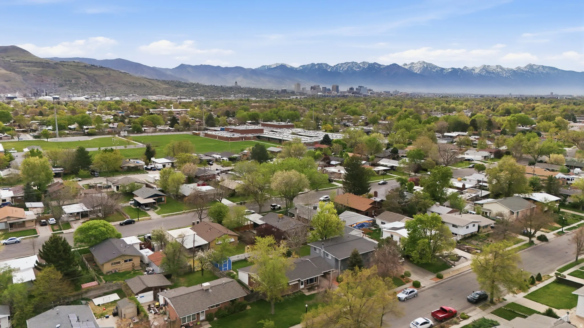 Aerial perspective of suburban area with a mountainous background