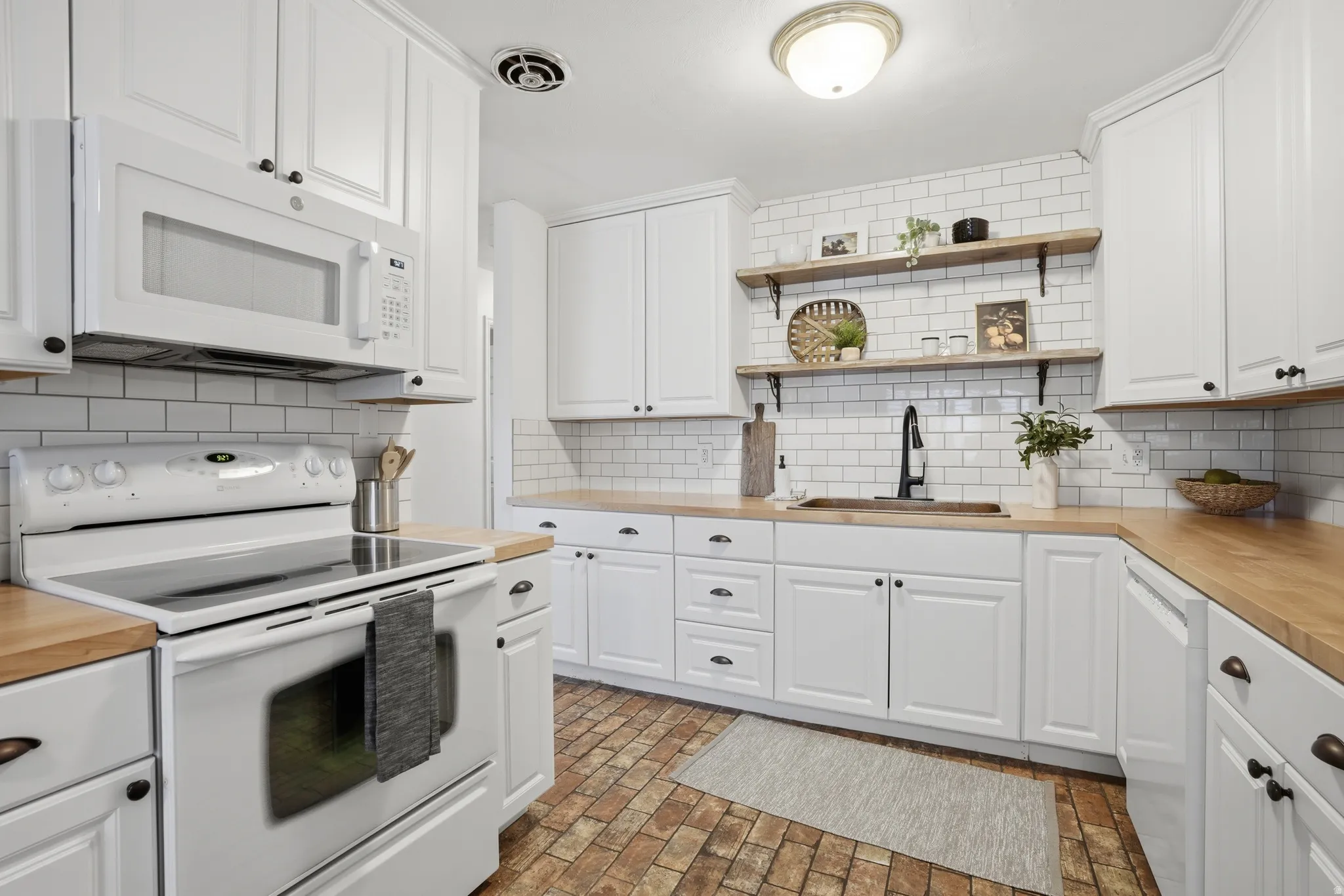 Kitchen with white appliances and white cabinetry