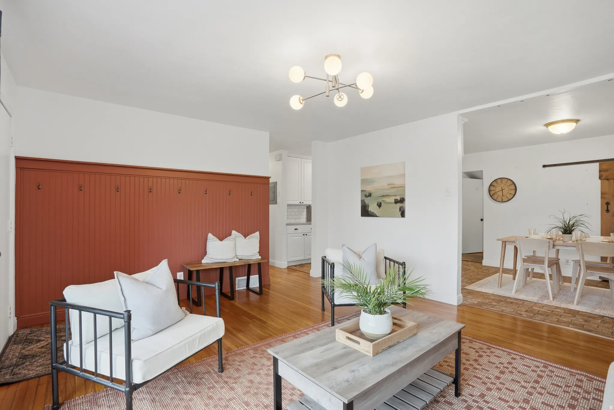 Living area with light wood finished floors and a chandelier