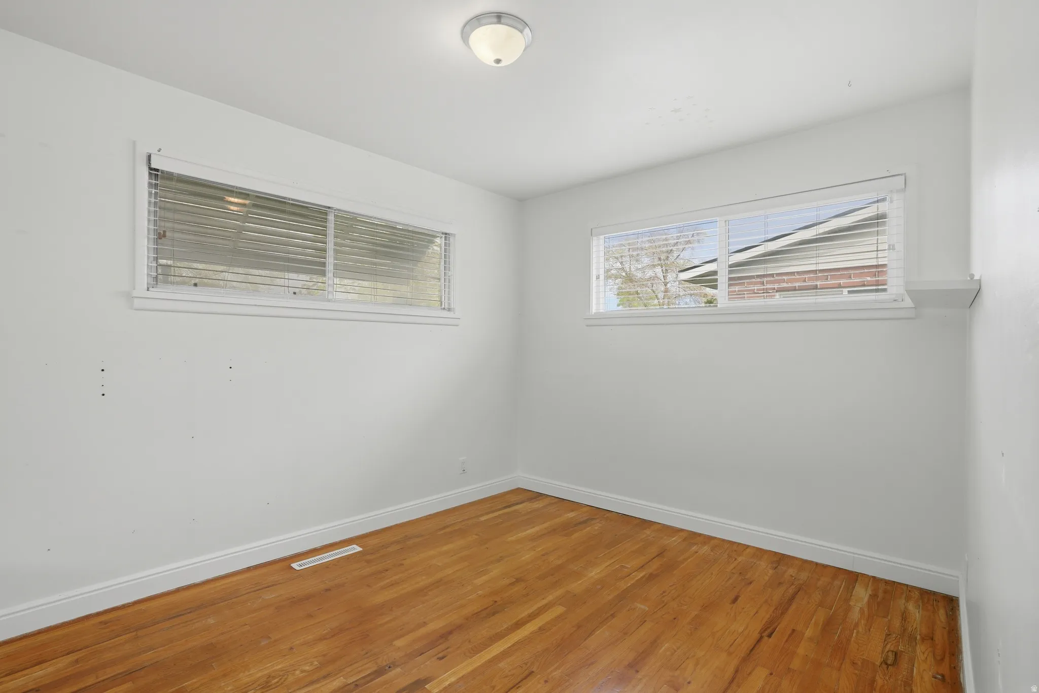 Bedroom 3 with baseboards and light wood-type flooring