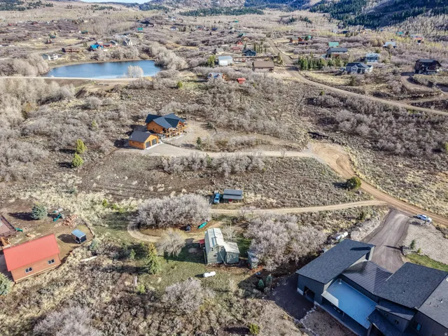 Aerial view of property and surrounding area with a nearby body of water