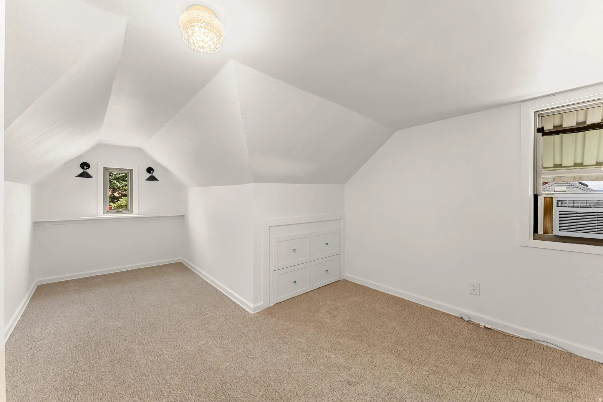Bonus room featuring light colored carpet and vaulted ceiling