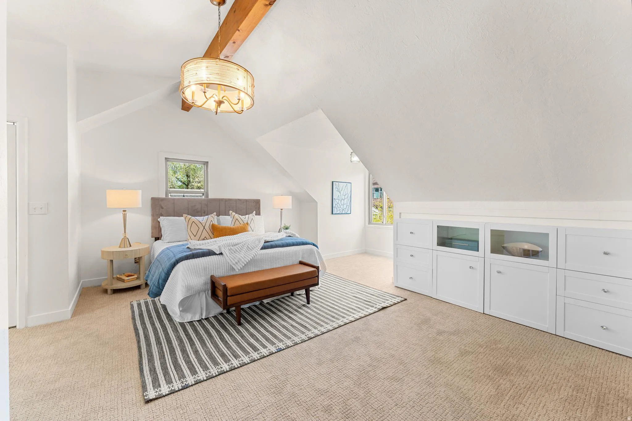 Bedroom with light carpet and vaulted ceiling with beams