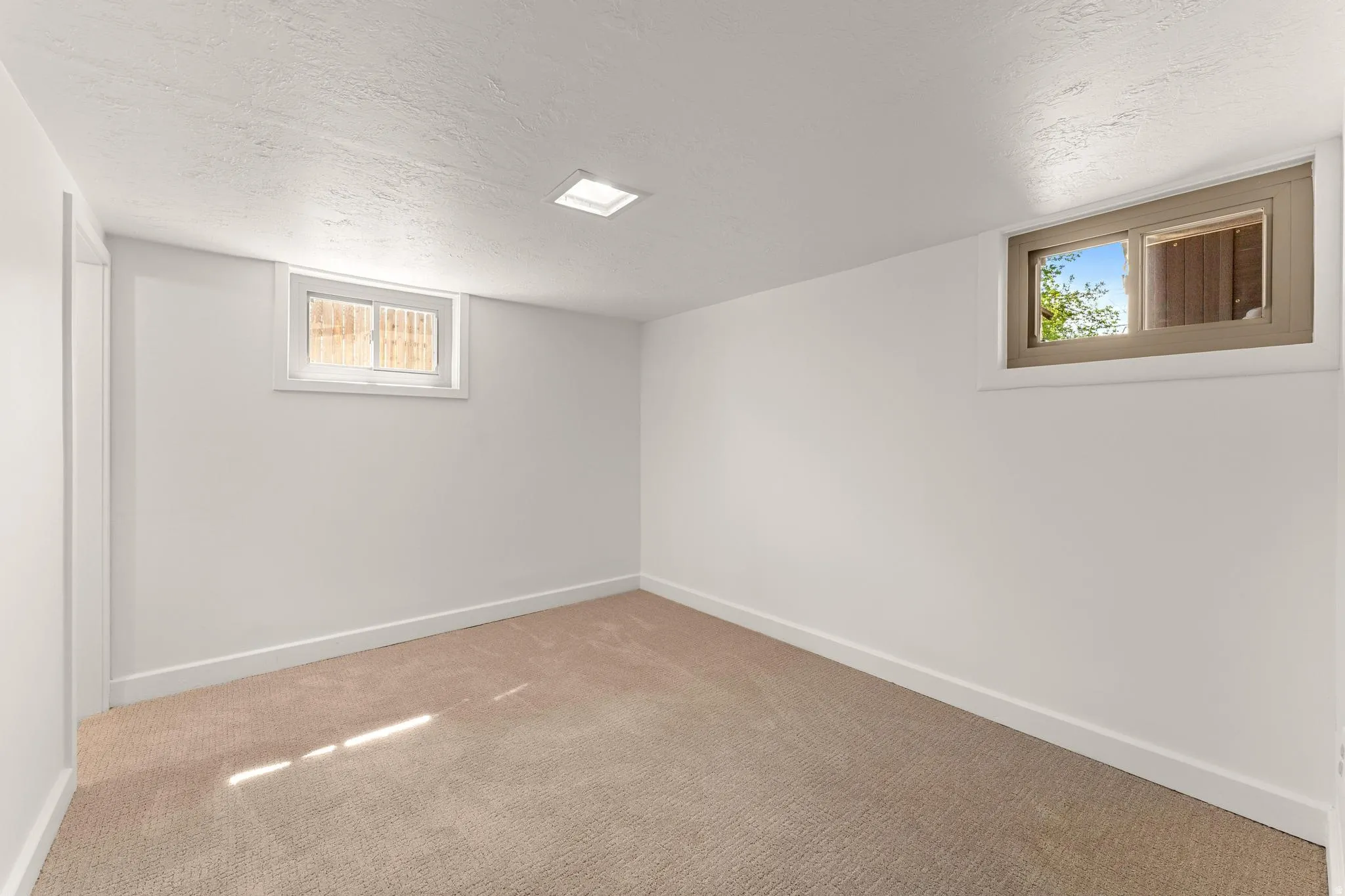 Basement featuring a textured ceiling and carpet