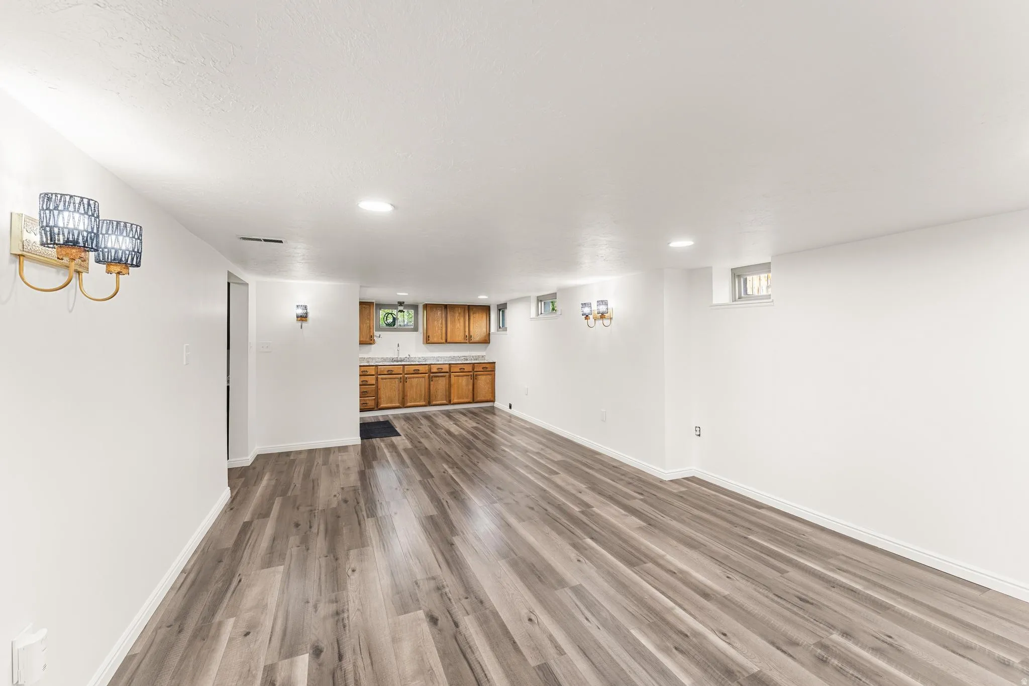 Unfurnished living room featuring dark wood-style flooring and recessed lighting
