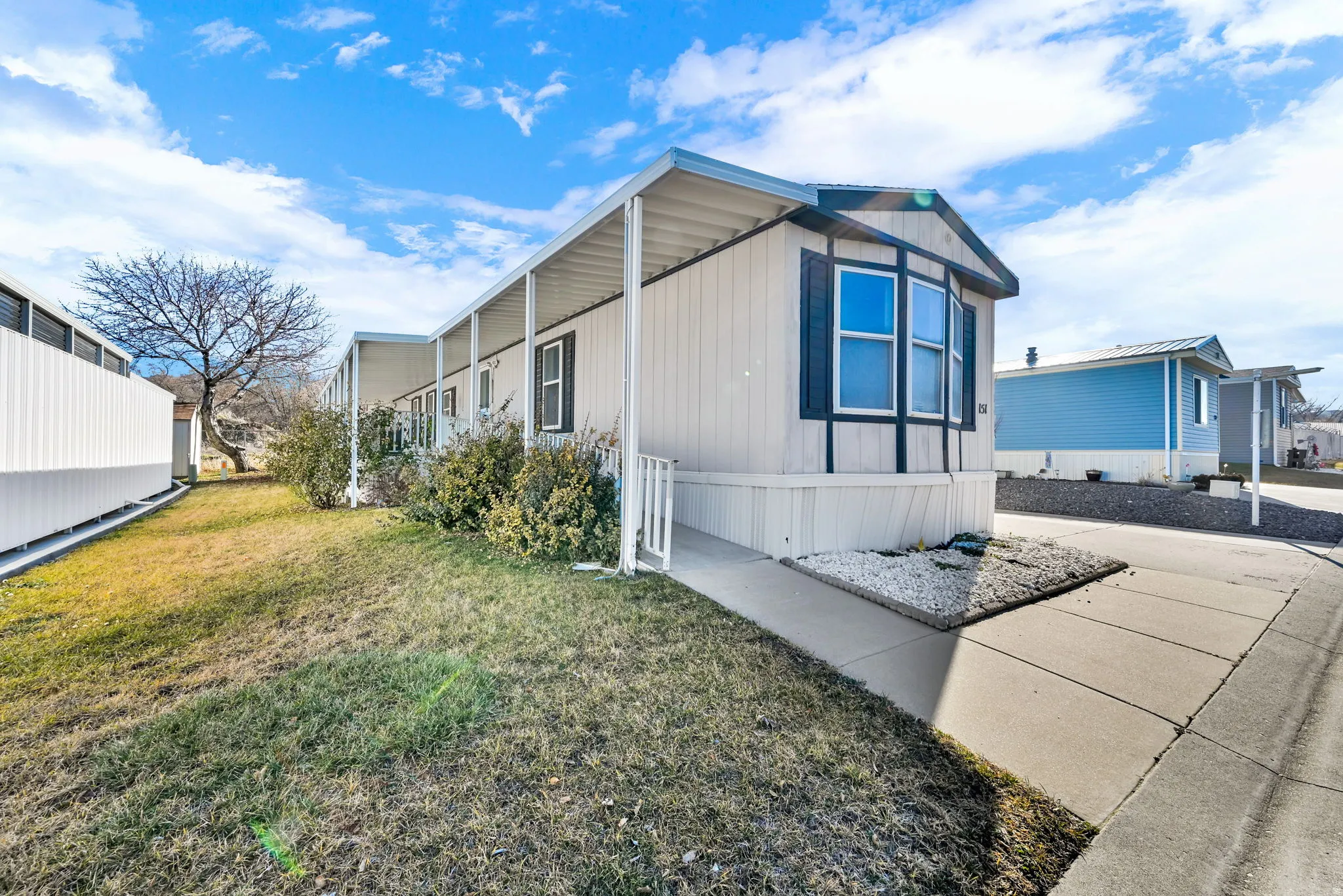 View of side of home featuring a yard