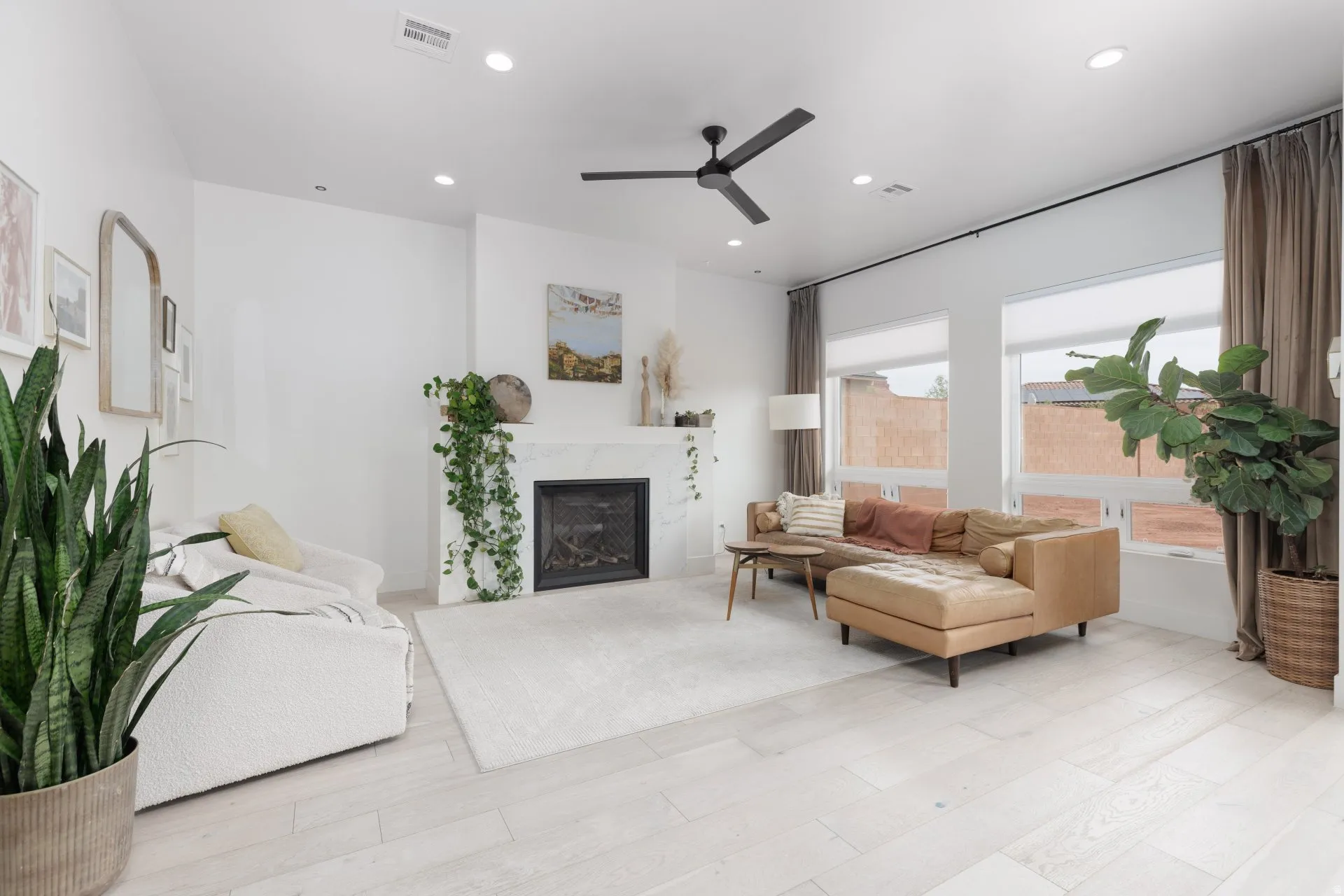 Living room with ceiling fan, recessed lighting, light wood-style flooring, and a fireplace