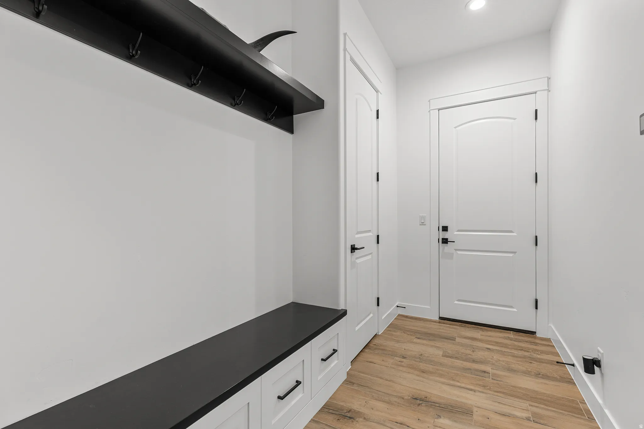 Mudroom featuring light wood-style floors and recessed lighting