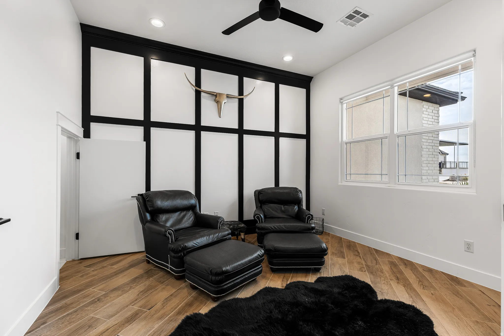 Living area featuring ceiling fan, light wood finished floors, and recessed lighting