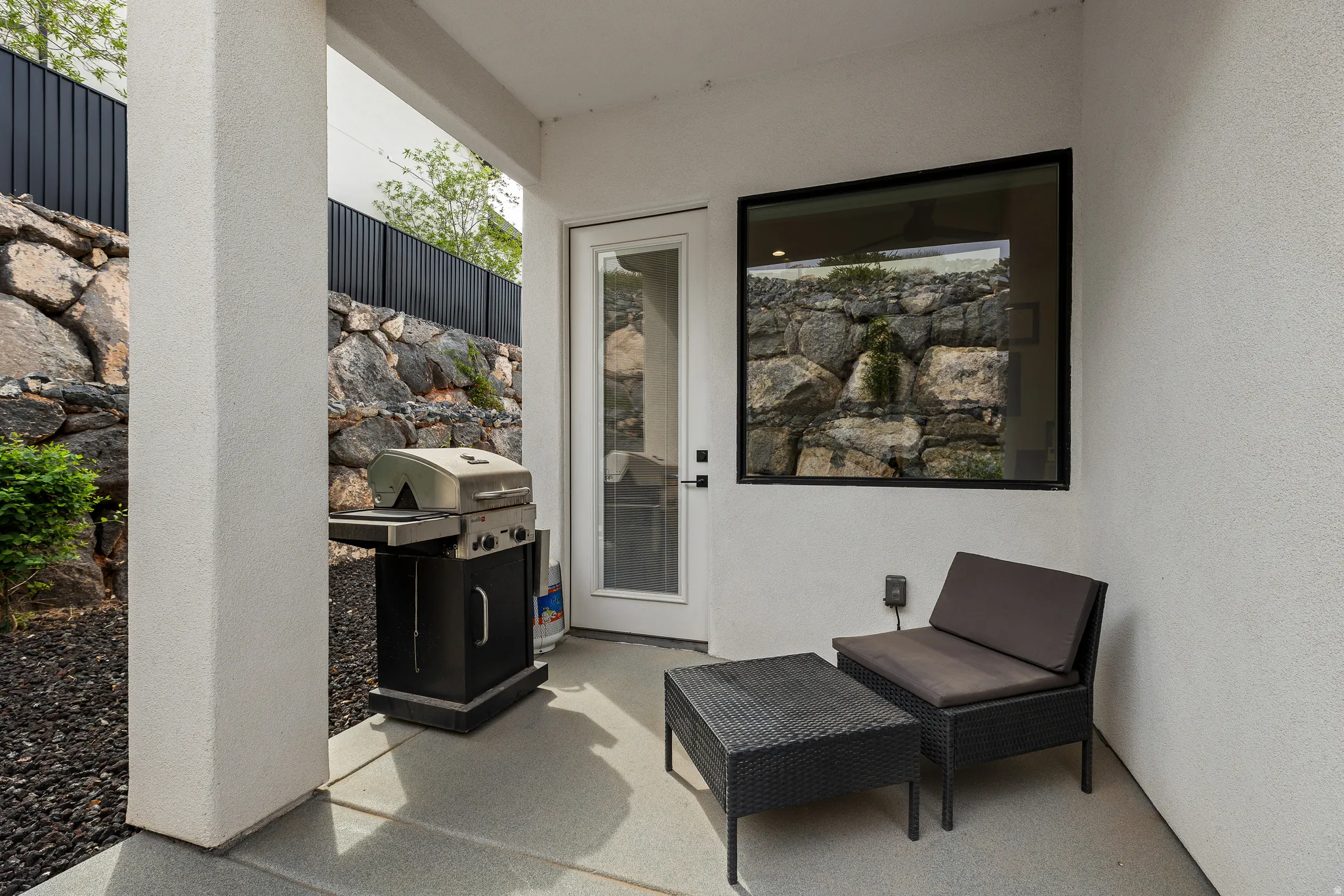 Property entrance featuring a patio and stucco siding