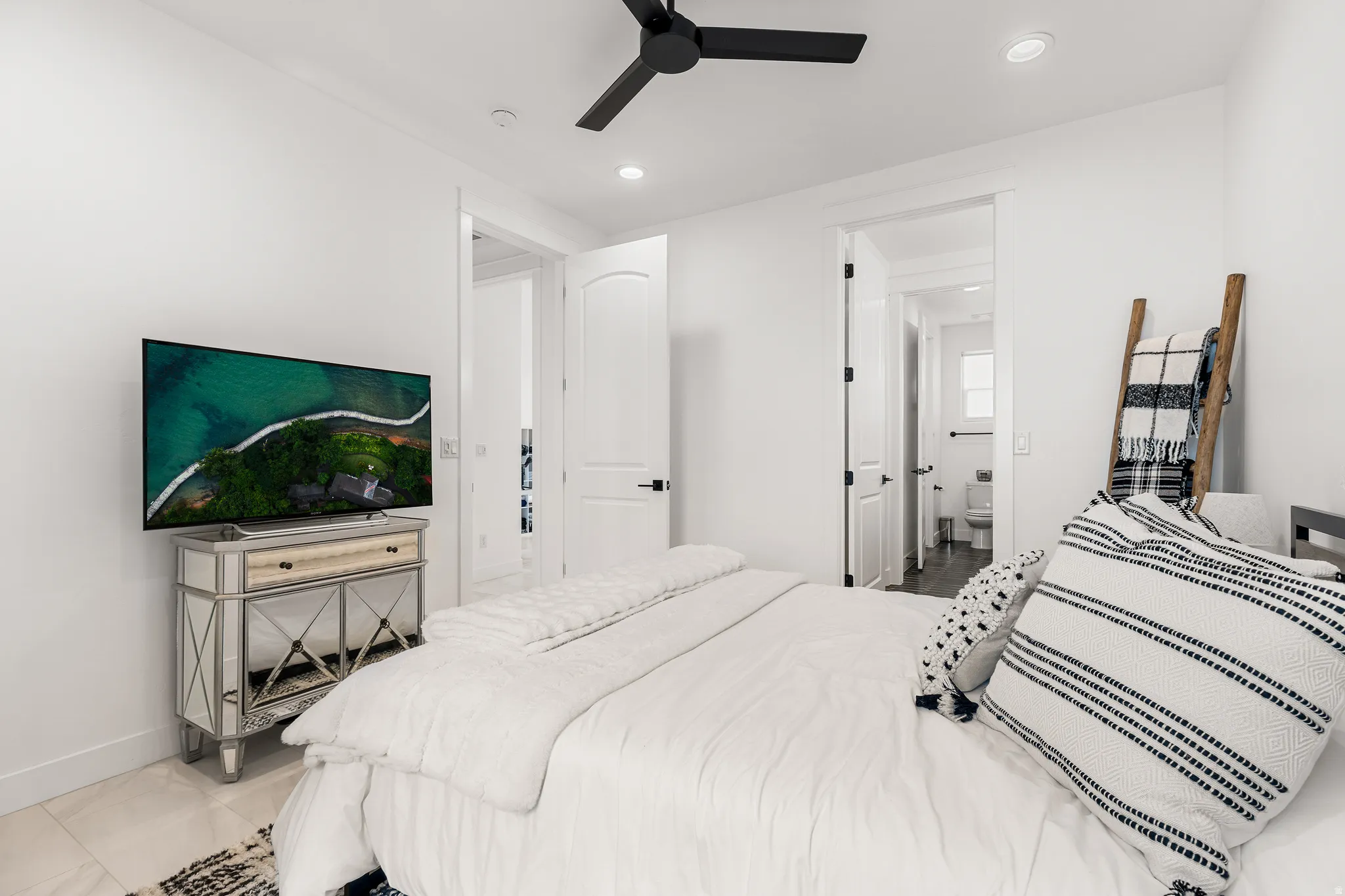 Bedroom featuring a ceiling fan, recessed lighting, and connected bathroom