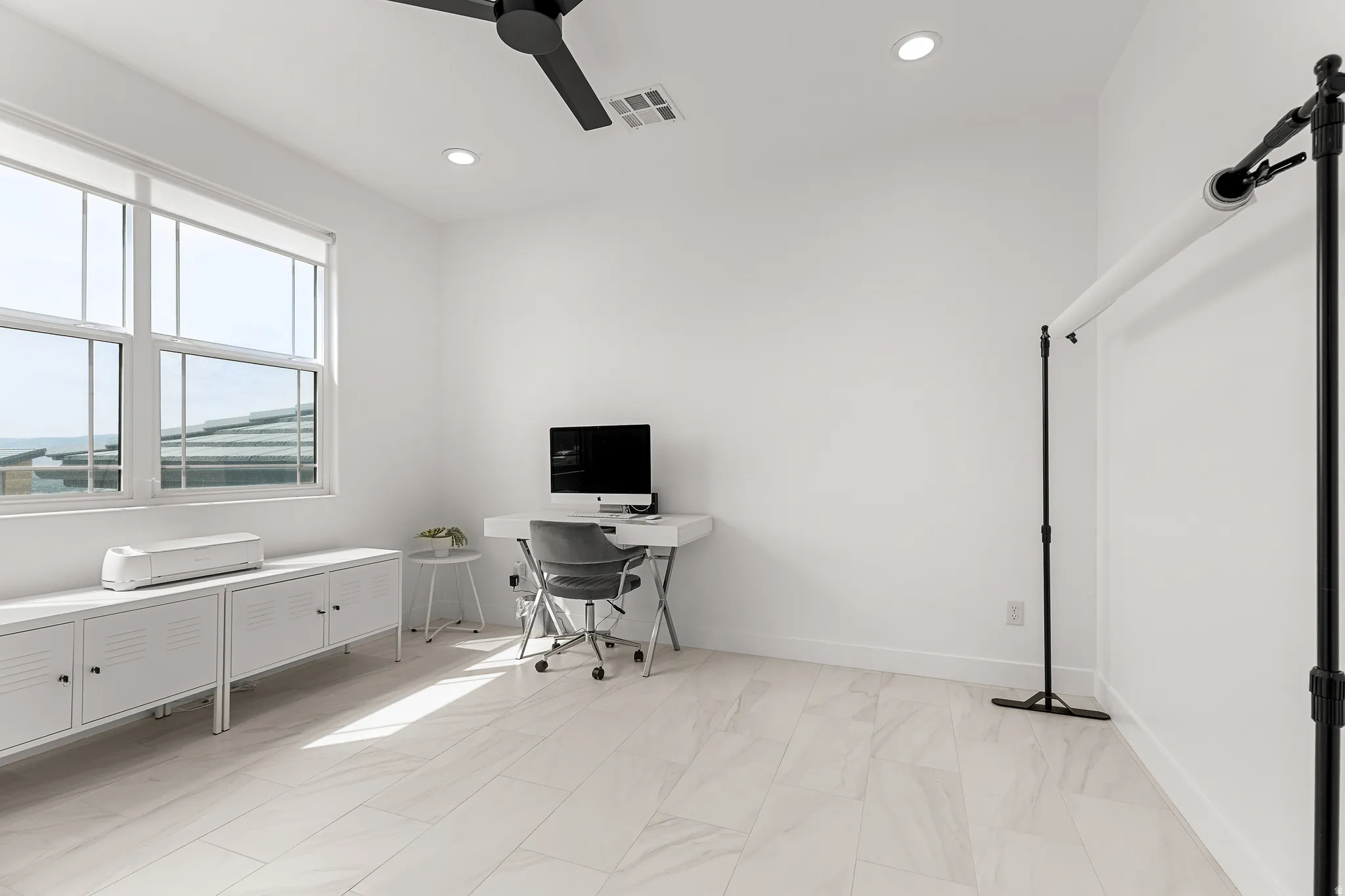 Office area with a ceiling fan and recessed lighting