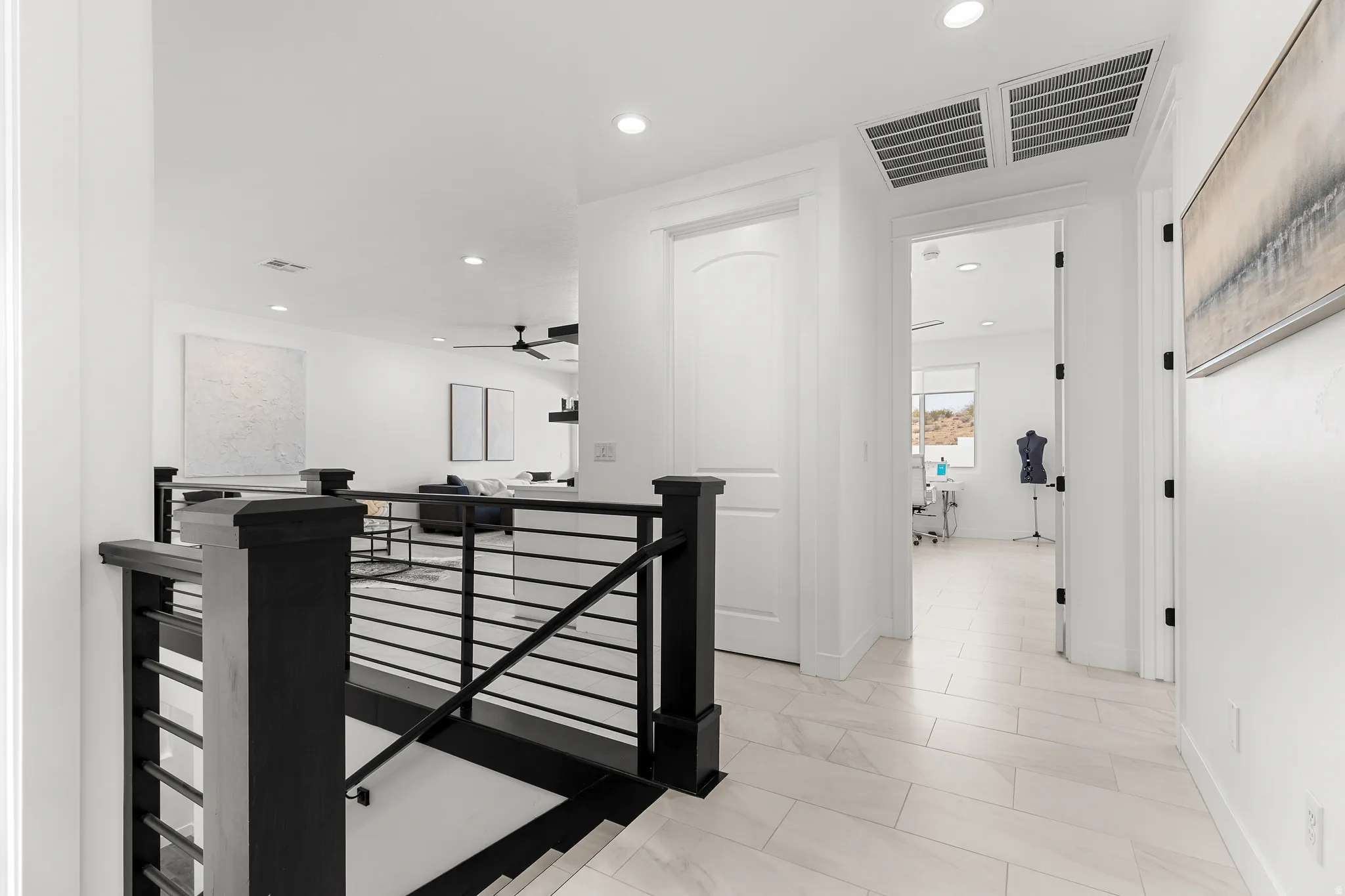 Hall featuring an upstairs landing, recessed lighting, and light marble finish flooring