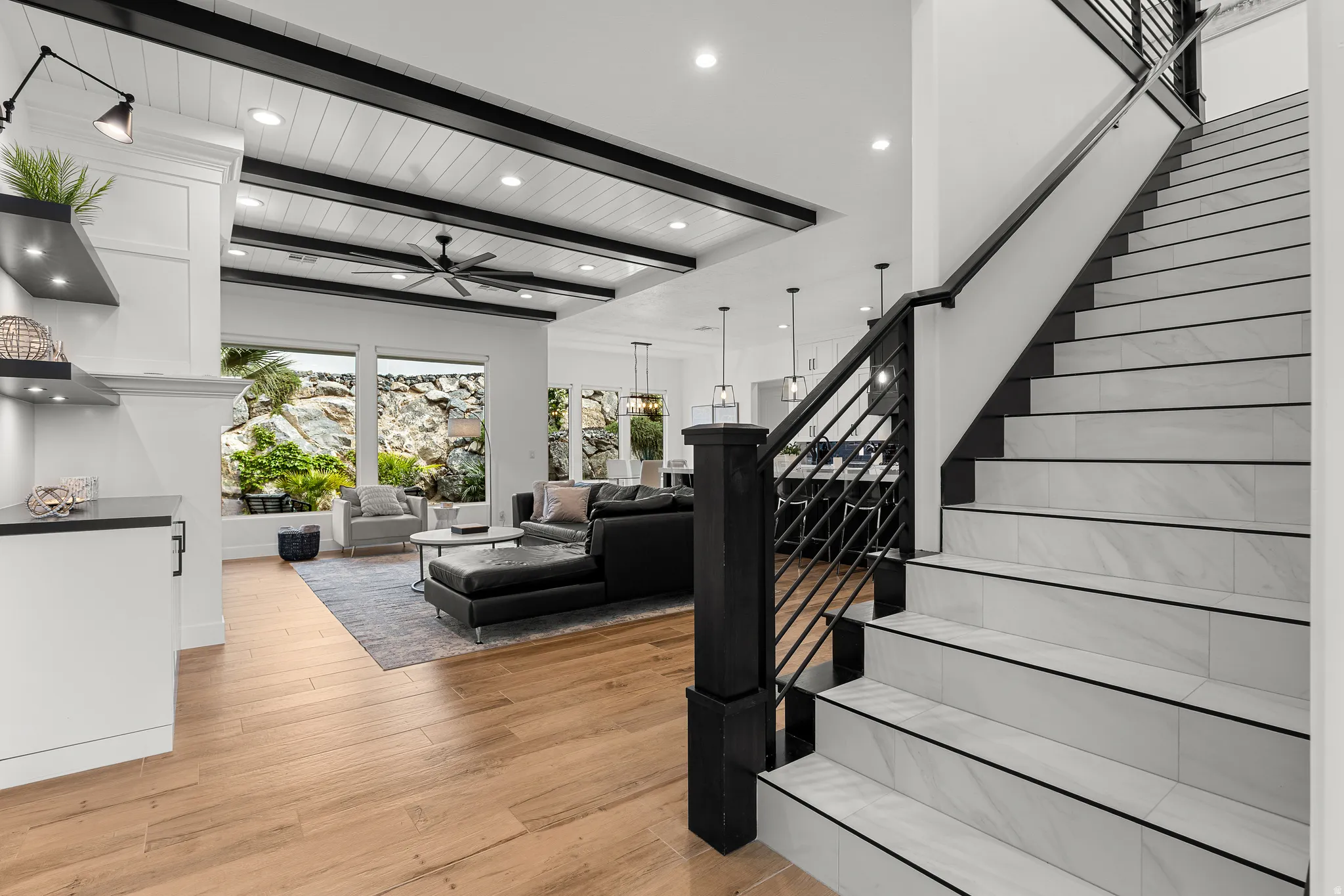 Staircase with wood finished floors, a ceiling fan, recessed lighting, and a wooden ceiling with exposed beams