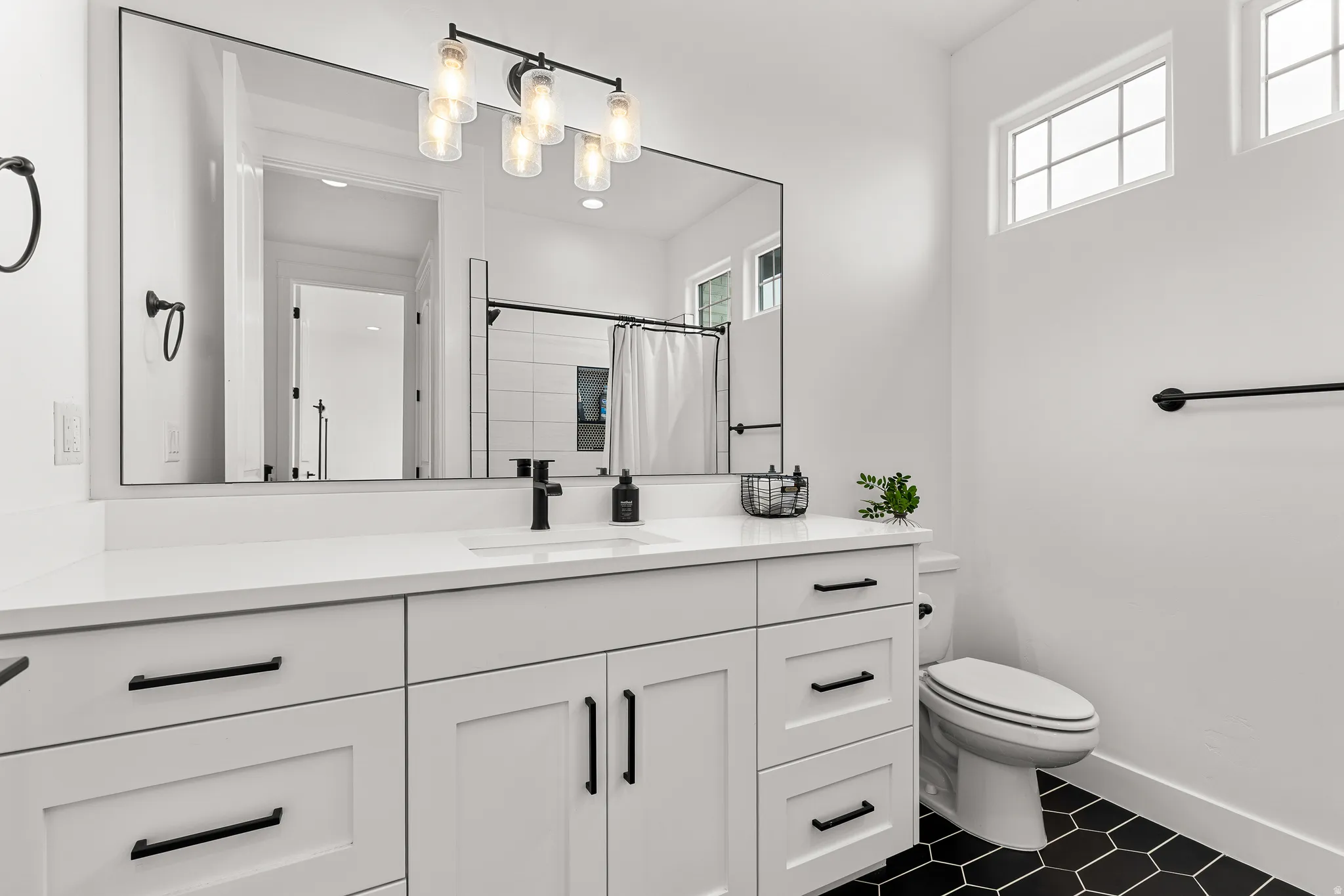 Full bathroom with vanity and a shower with shower curtain