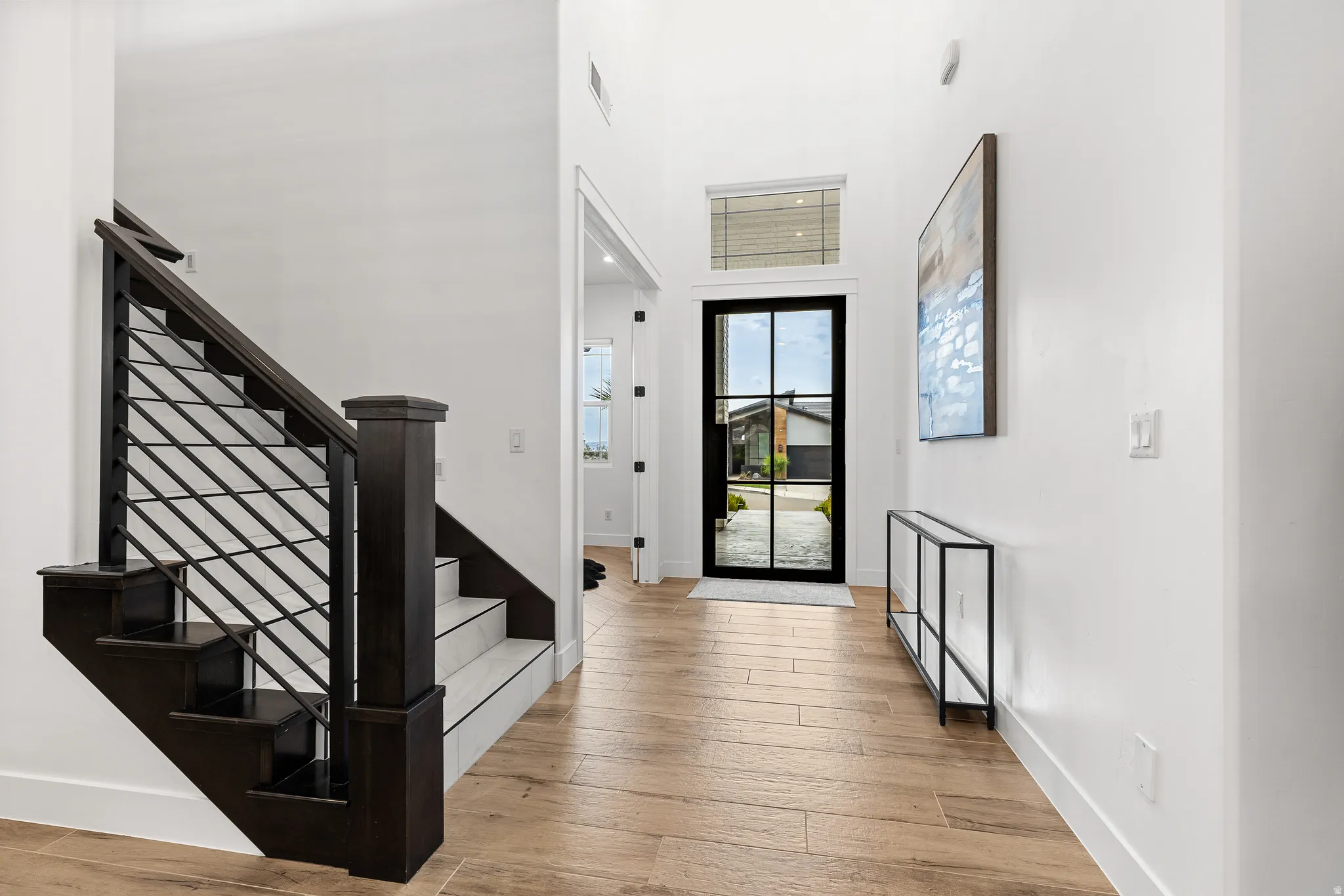 Foyer with a high ceiling and light wood-type flooring