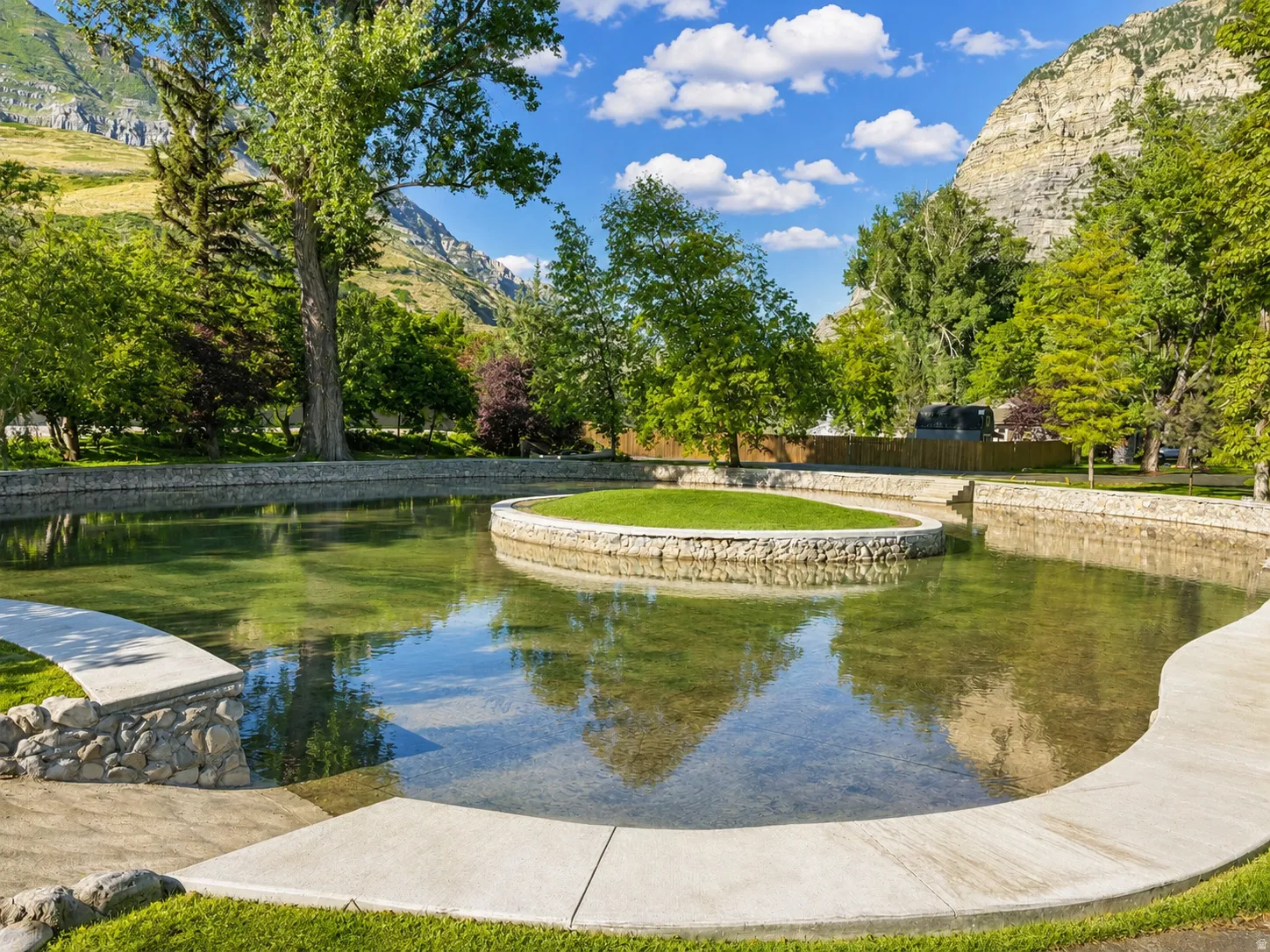 Landscaped water feature with a central grassy island