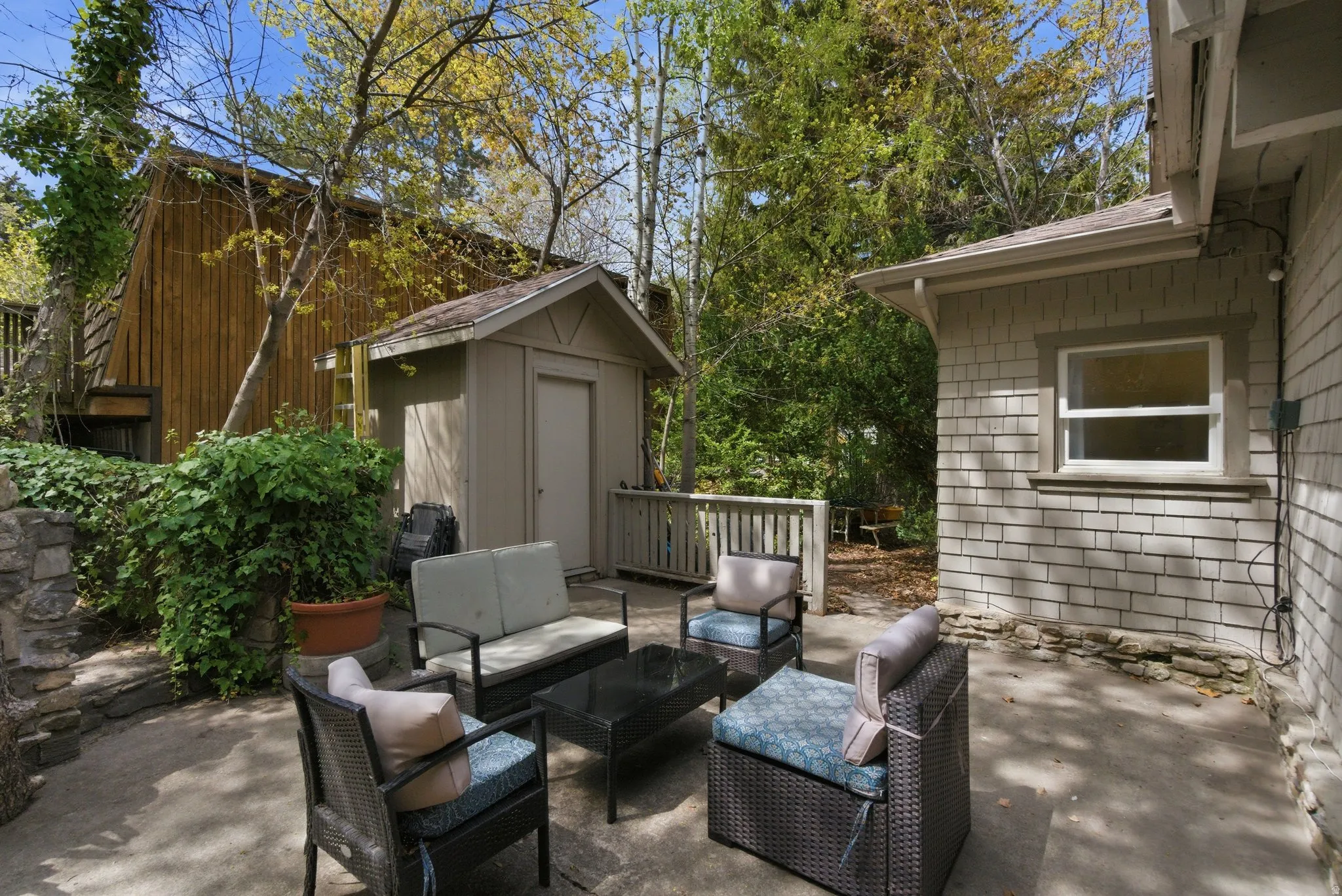 View of patio featuring outdoor lounge area and a storage unit