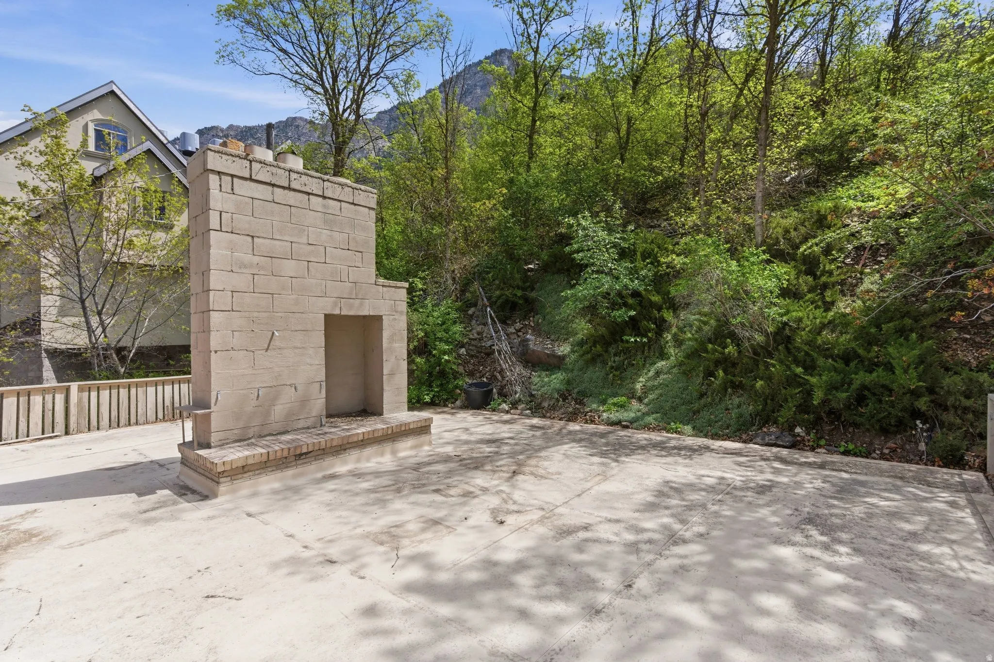 View of patio / terrace with an outdoor brick fireplace and a mountain view