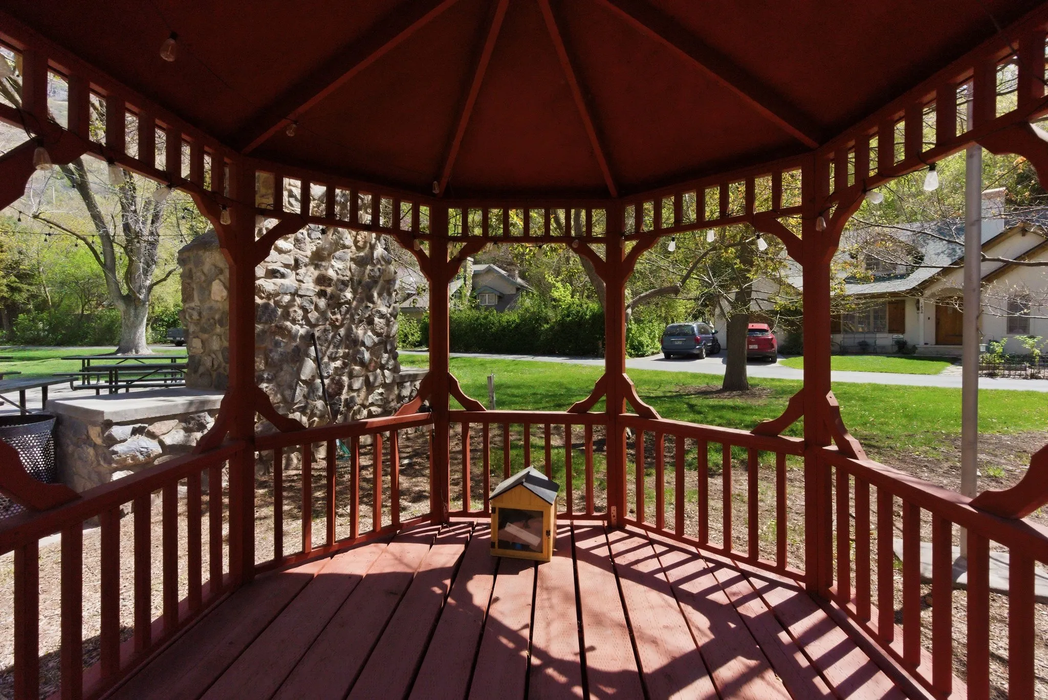 Deck featuring a yard, a gazebo, and a residential view