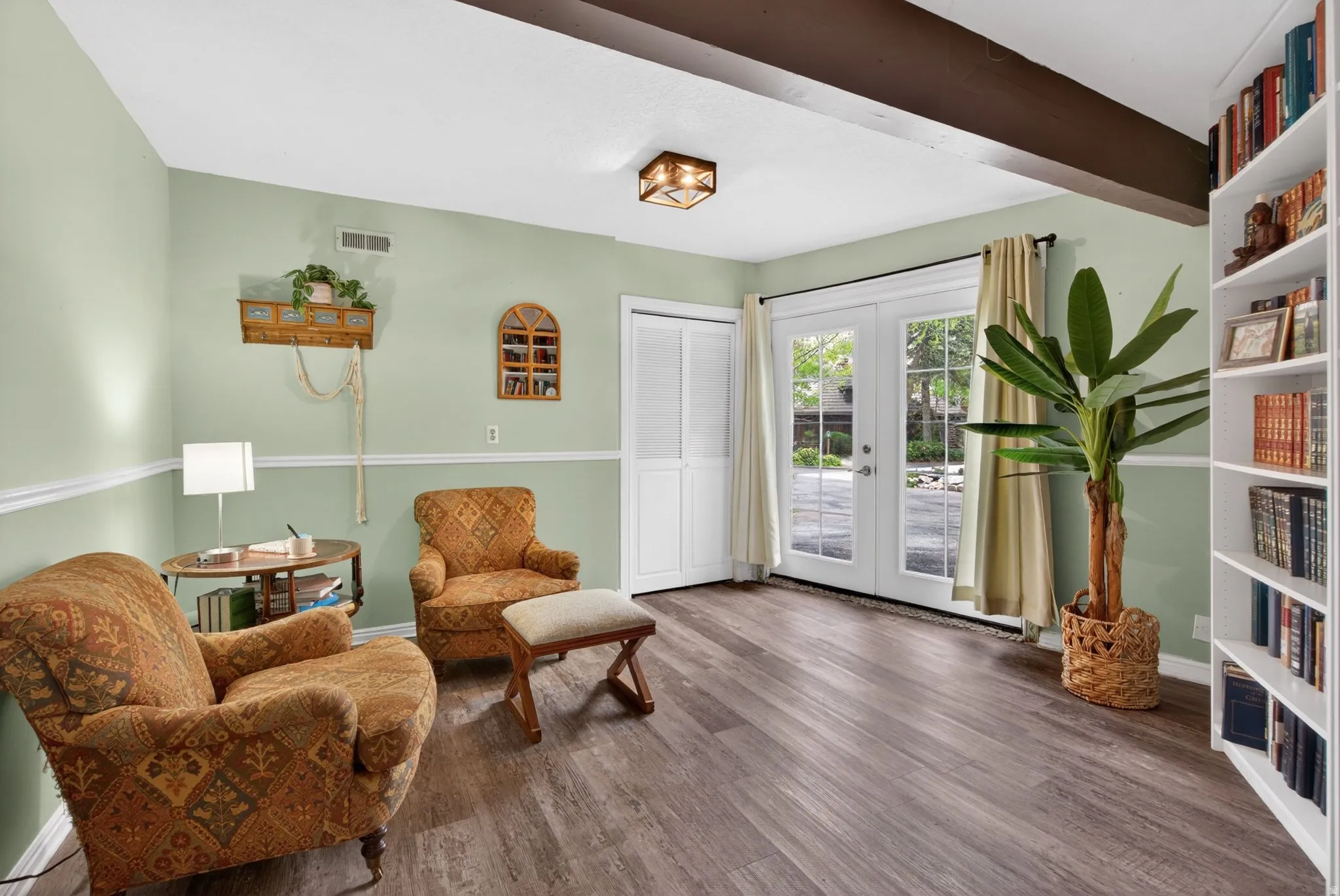 Living area featuring french doors and dark wood-style flooring