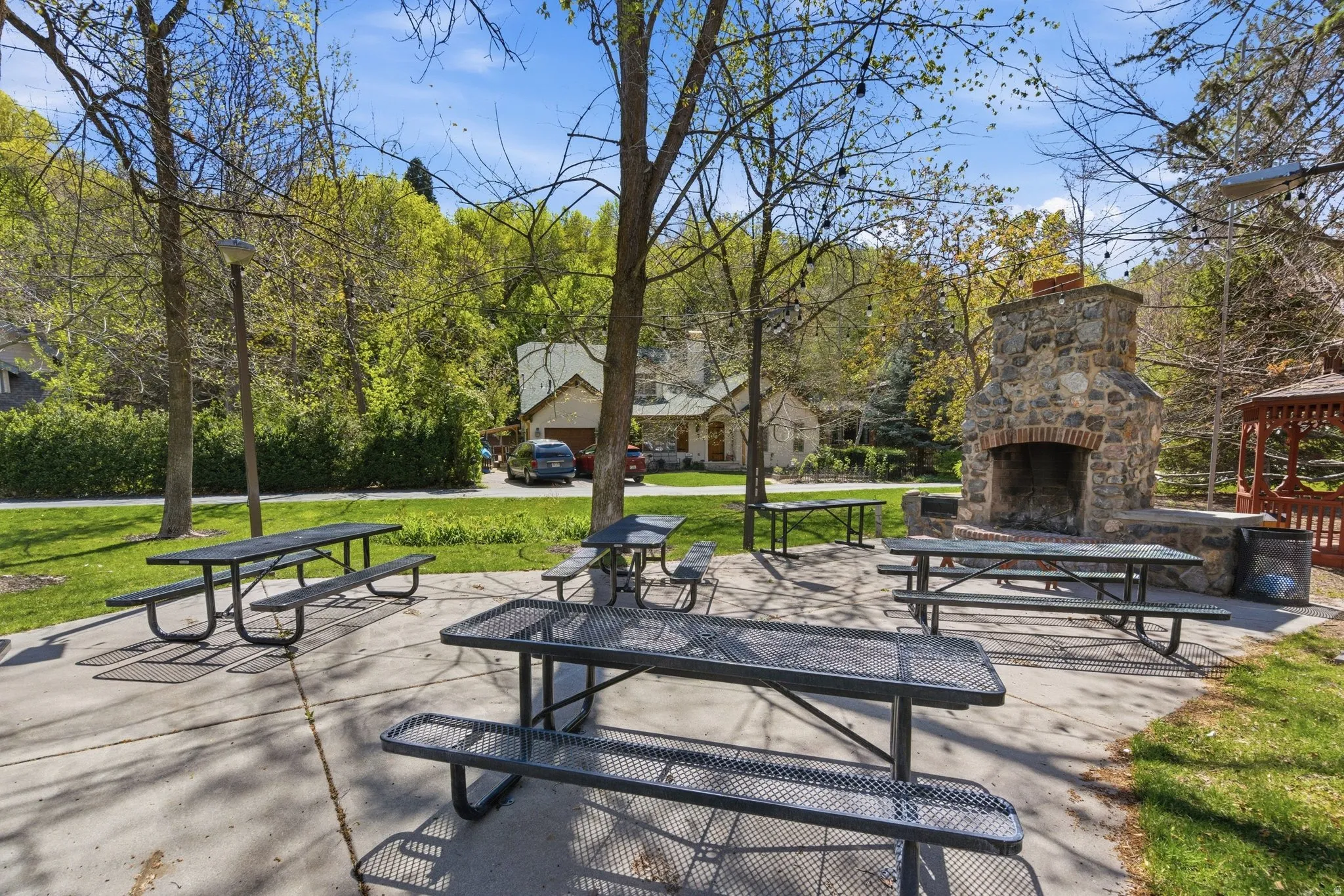 Surrounding community featuring a patio area, a gazebo, and view of scattered trees