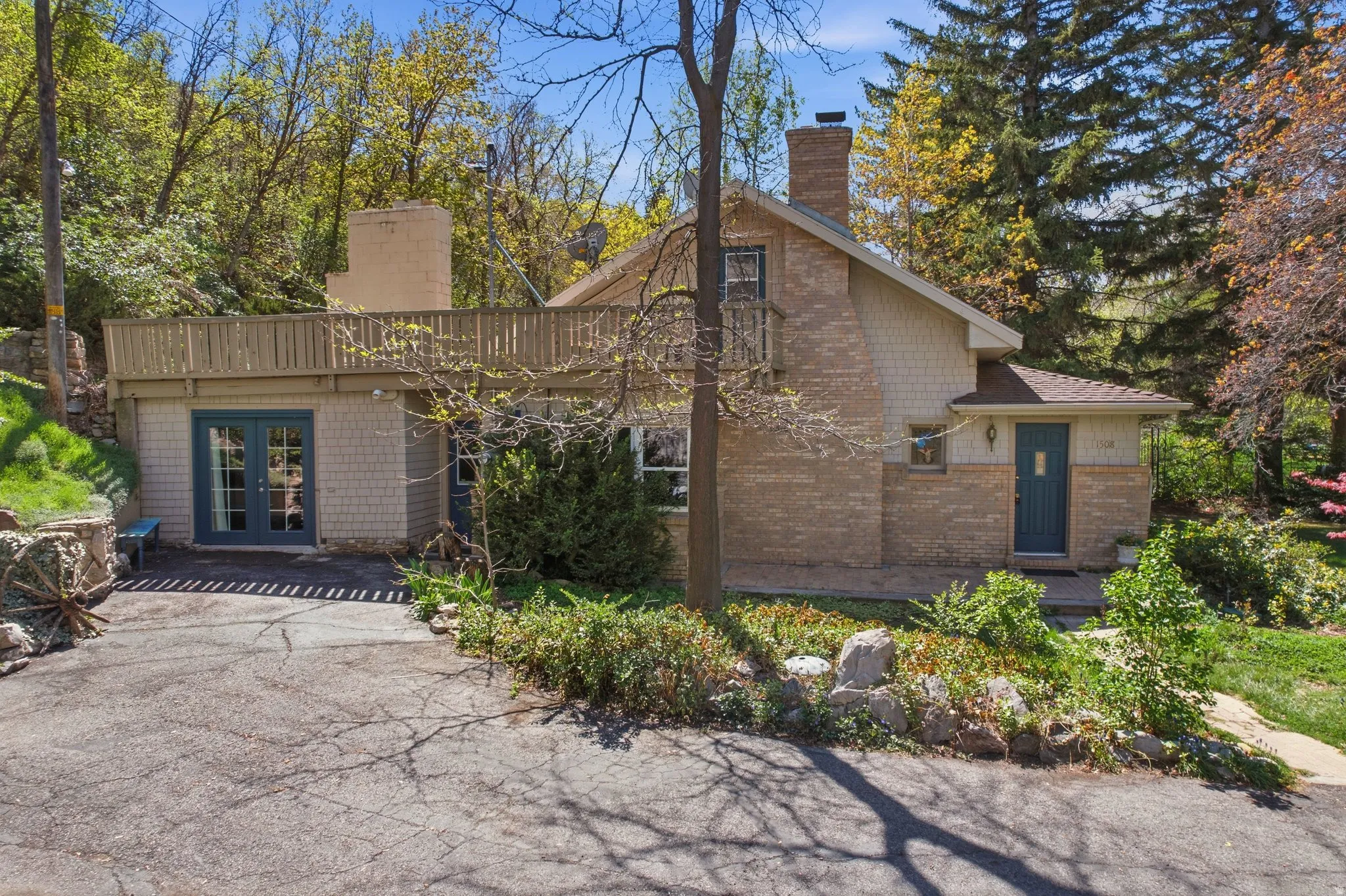 Back of house with french doors, a chimney, and brick siding
