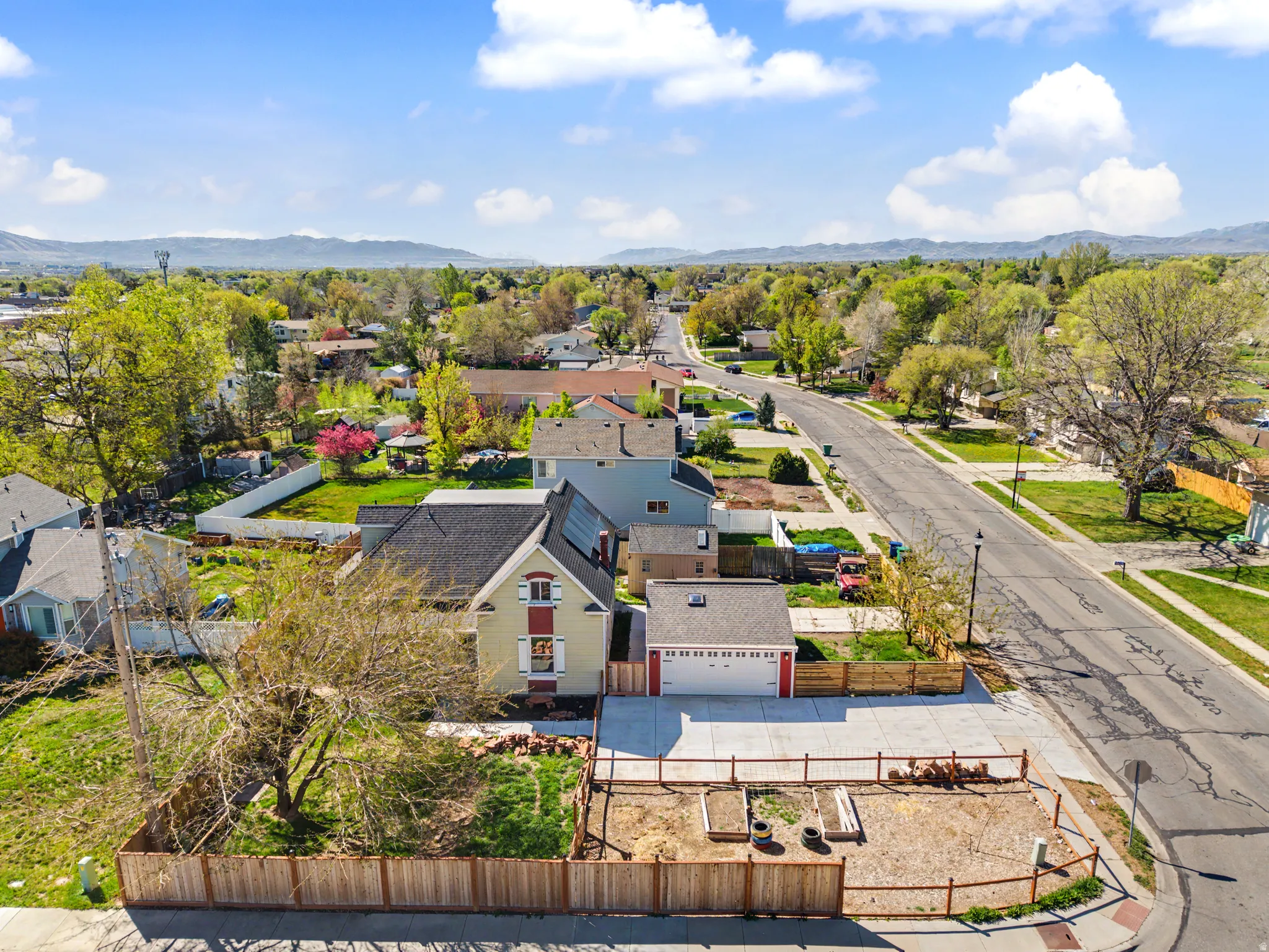 Aerial perspective of suburban area featuring a mountainous background