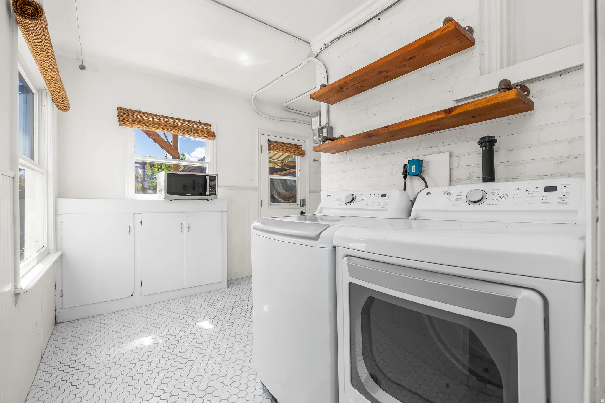Laundry area featuring a washer and clothes dryer.  Gas hookup