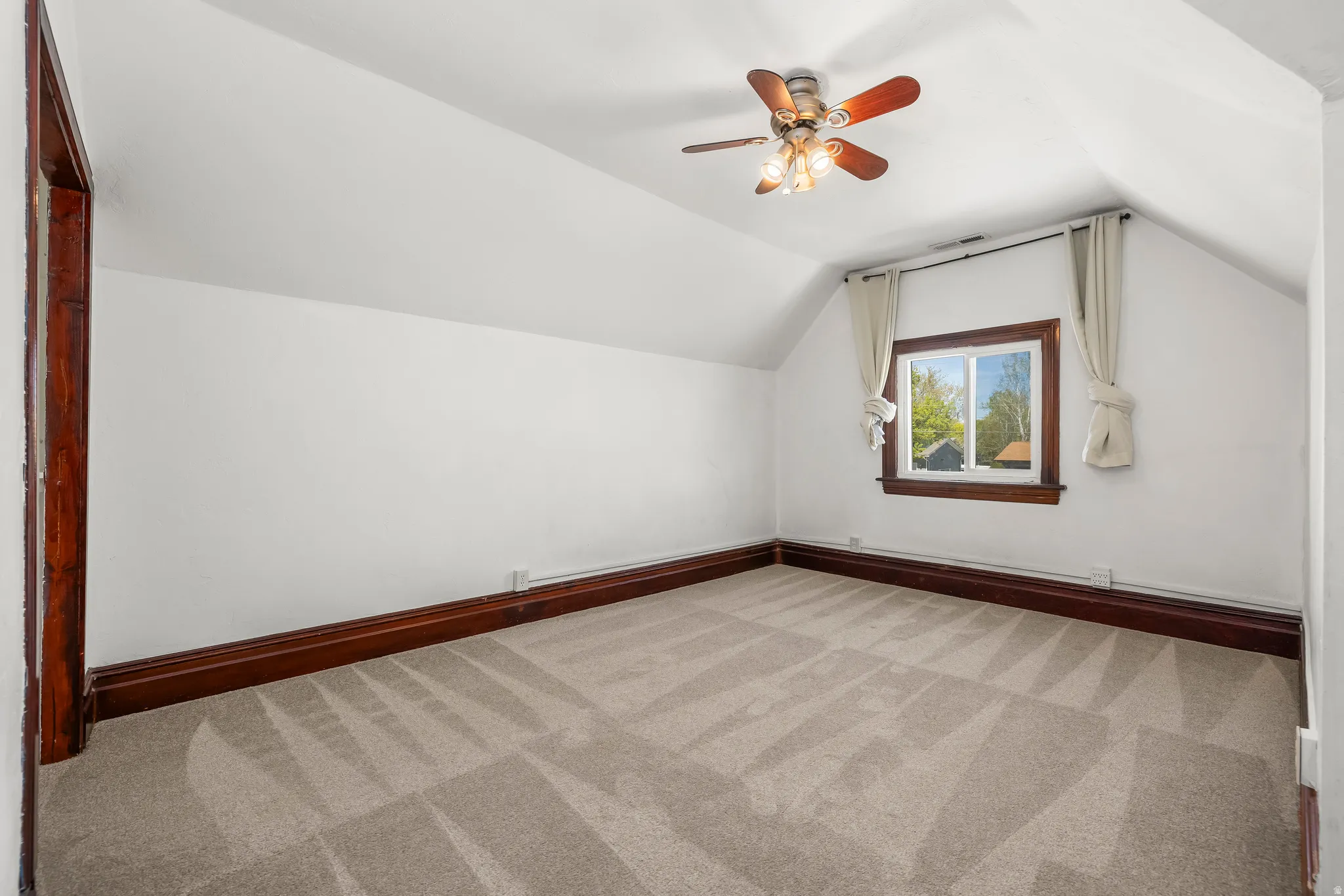 Bedroom 1 featuring light colored carpet and a ceiling fan