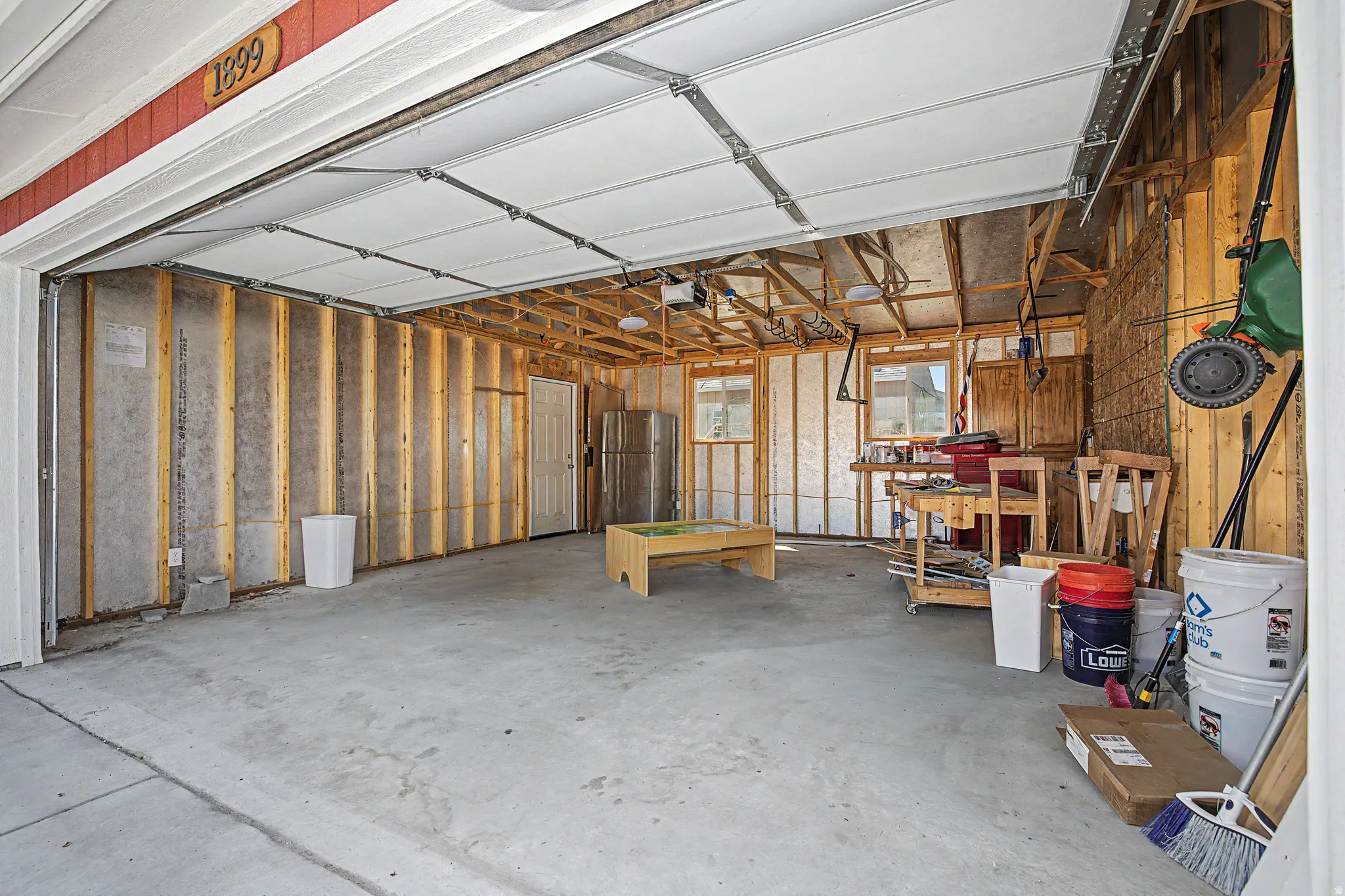 Garage featuring freestanding refrigerator