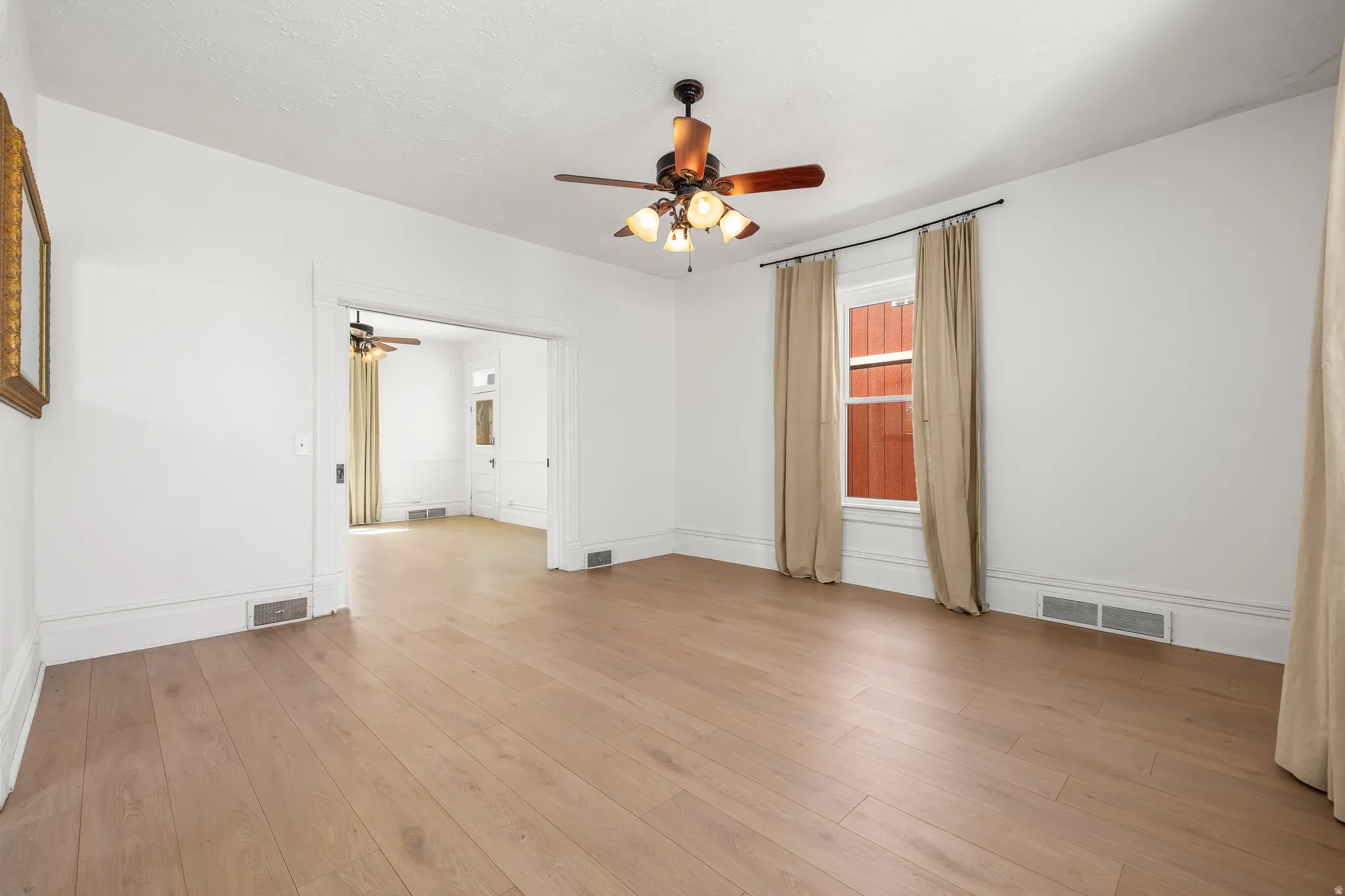 Living room featuring ceiling fan and light wood-style flooring