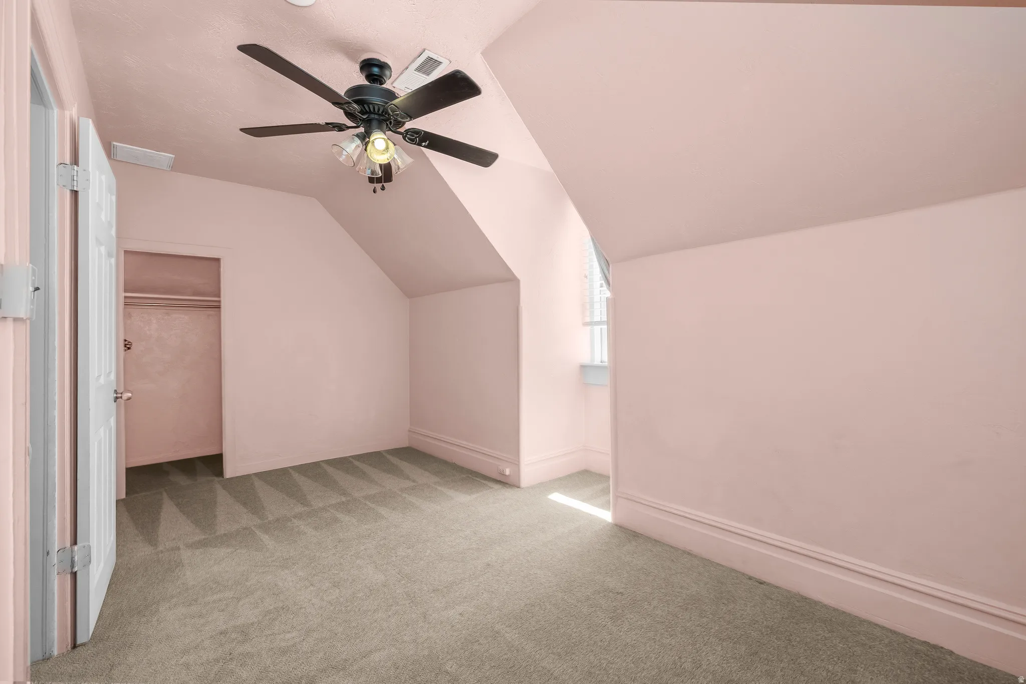 Bedroom 3 with vaulted ceiling, light colored carpet, and ceiling fan