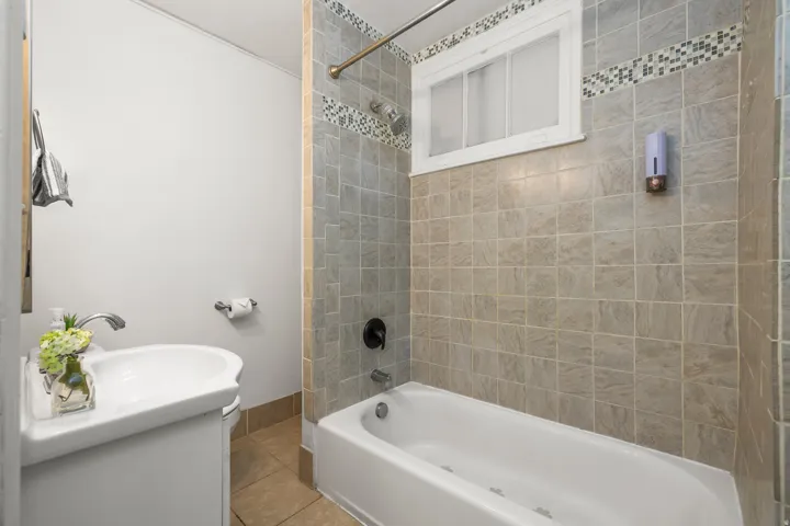 Full bathroom with shower / washtub combination, vanity, and tile patterned floors